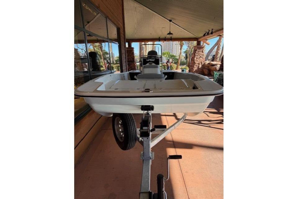 2026 Mako Pro Skiff 17 CC boat on trailer, displayed outdoors.