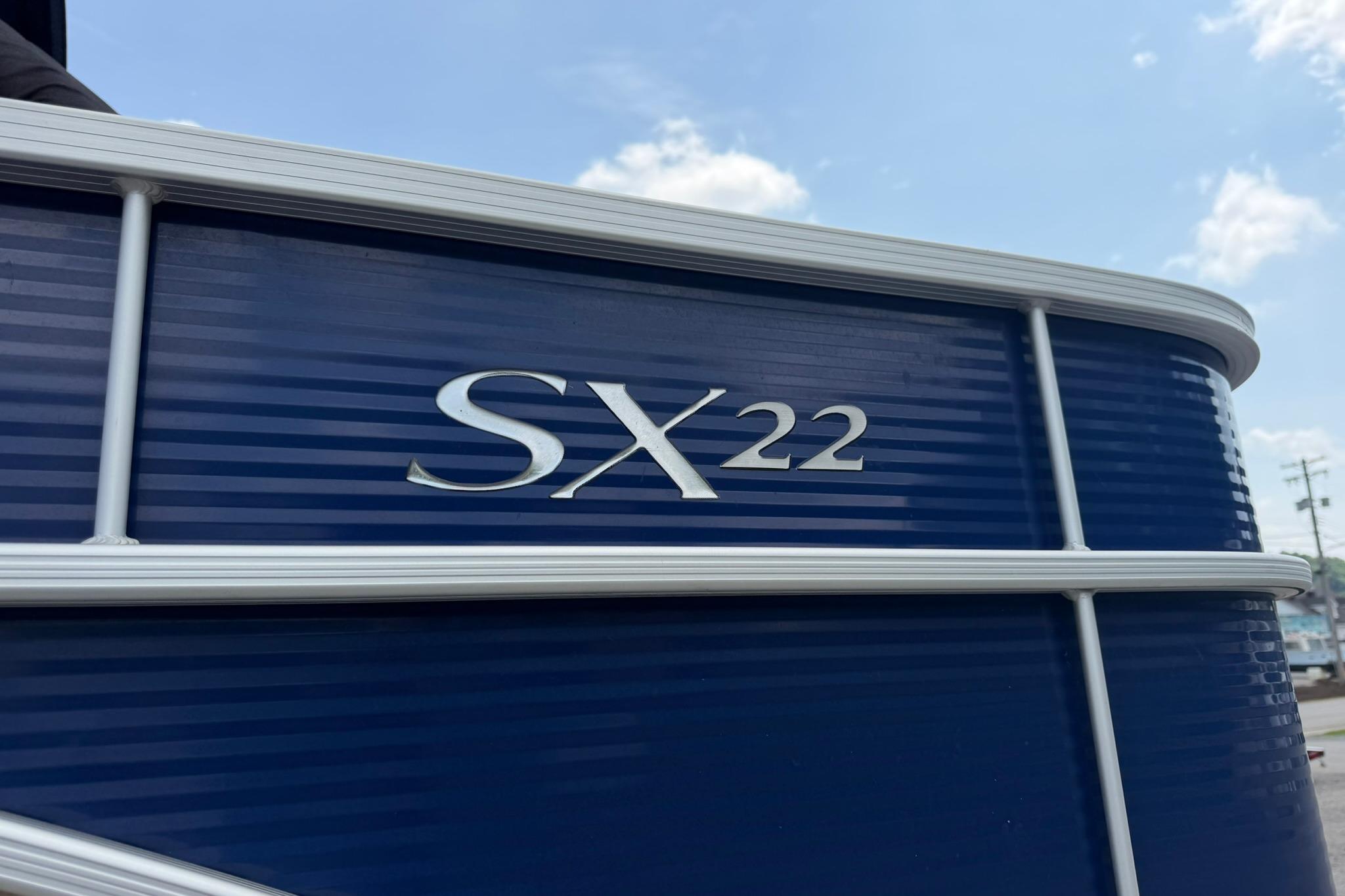 2020 Bennington SX 22 SFX pontoon boat with blue exterior and silver lettering.