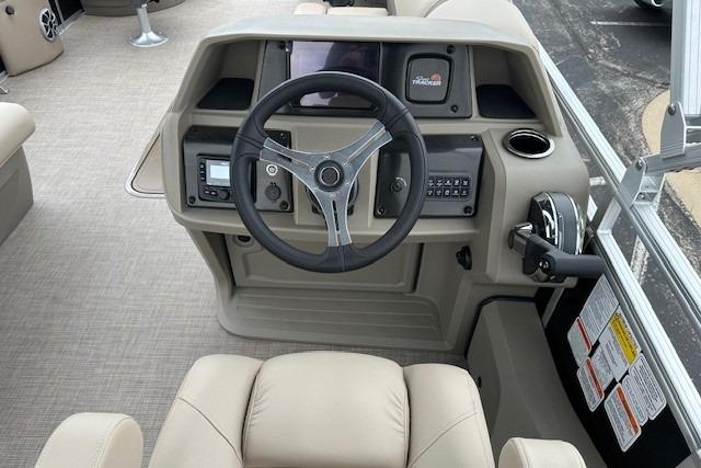2025 Sun Tracker Sportfish 24 XP3 boat dashboard with steering wheel and control panel.