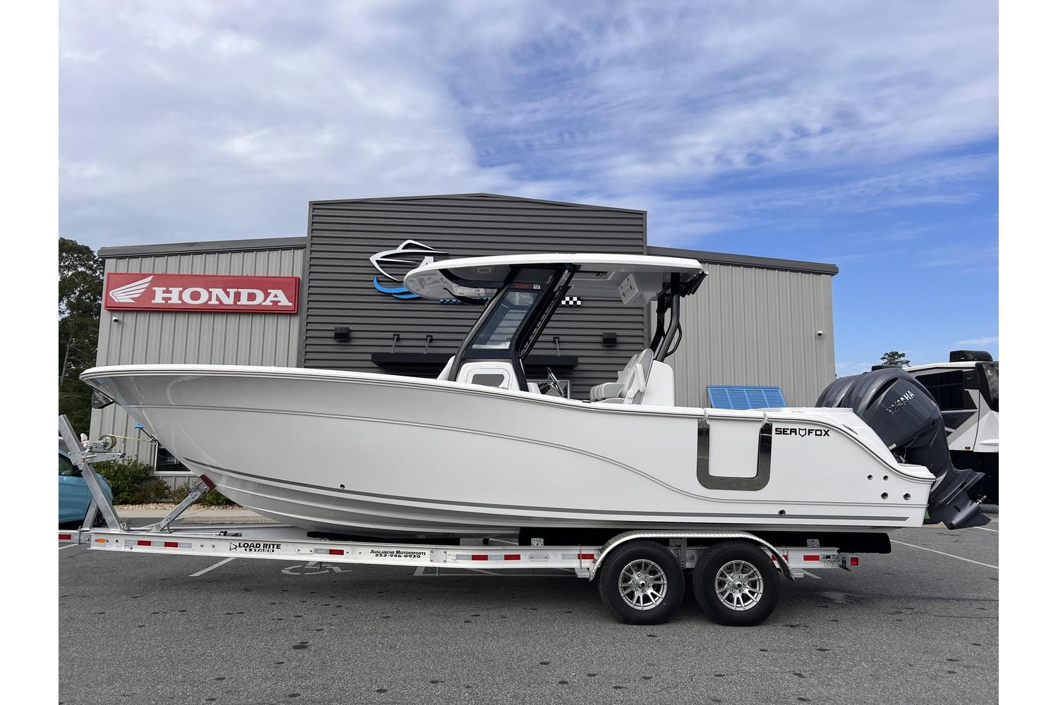 2025 Sea Fox 288 Commander boat on a trailer outside a Honda dealership.