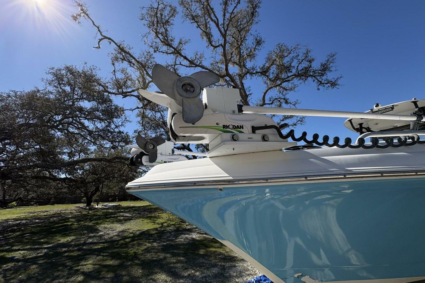 2008 Wellcraft 35 Scarab Sport boat with Rhodan trolling motor under sunny sky.