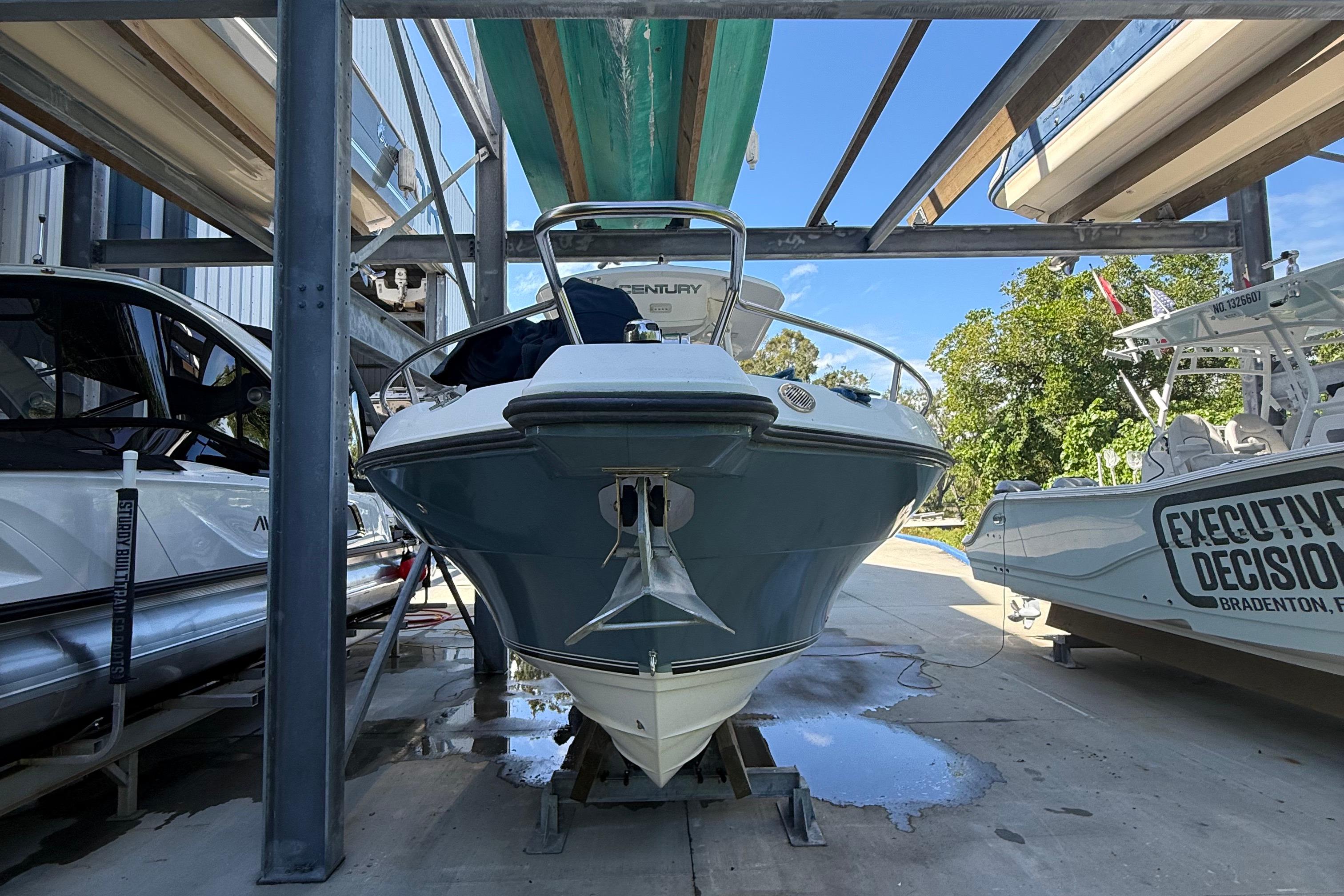 2008 Century 2901 Center Console boat in storage, surrounded by other boats.