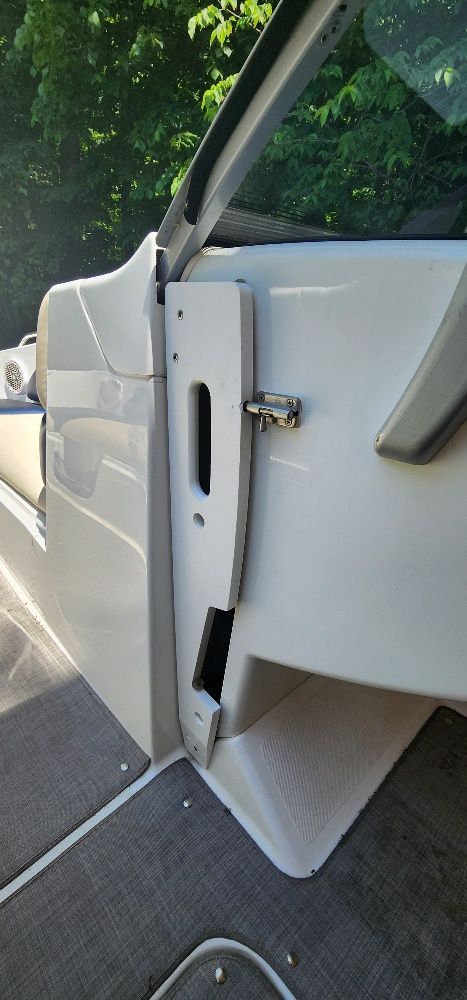 Close-up of a white boat part with gray carpeting.