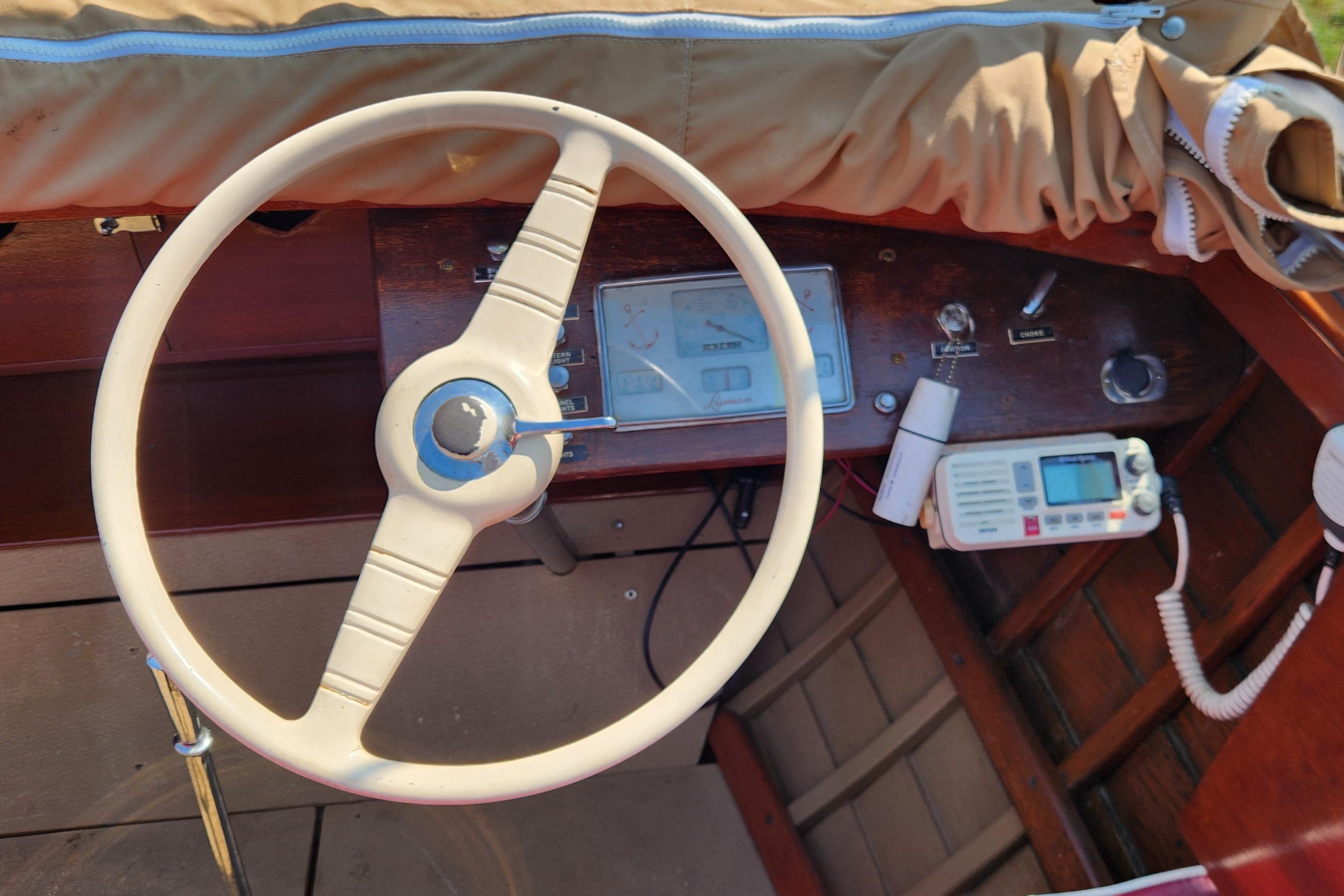 1958 Lyman Inboard Runabout dashboard with vintage steering wheel and controls.