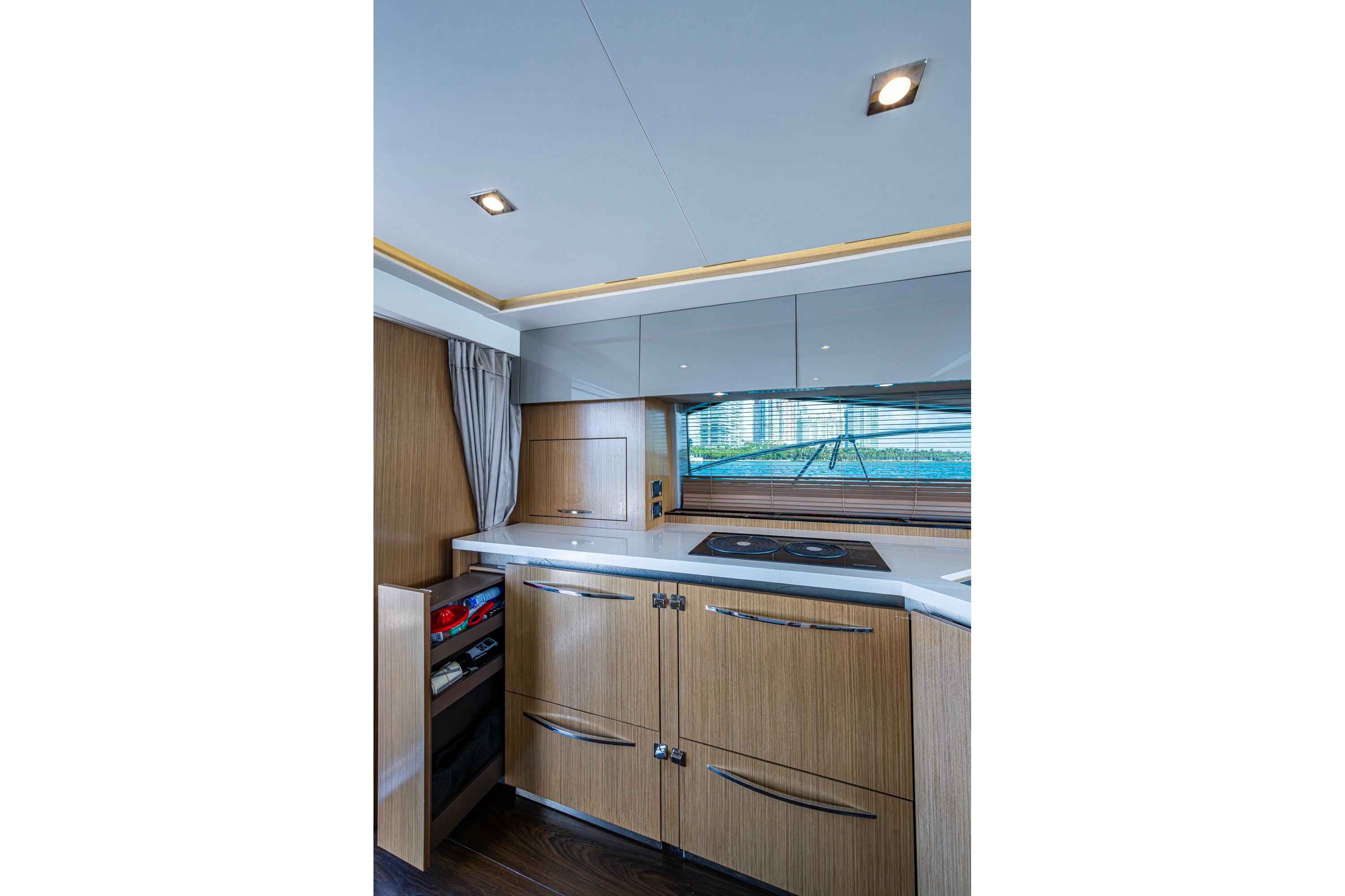 Luxurious kitchen interior of 2018 Sea Ray L550 Fly yacht with modern cabinetry.