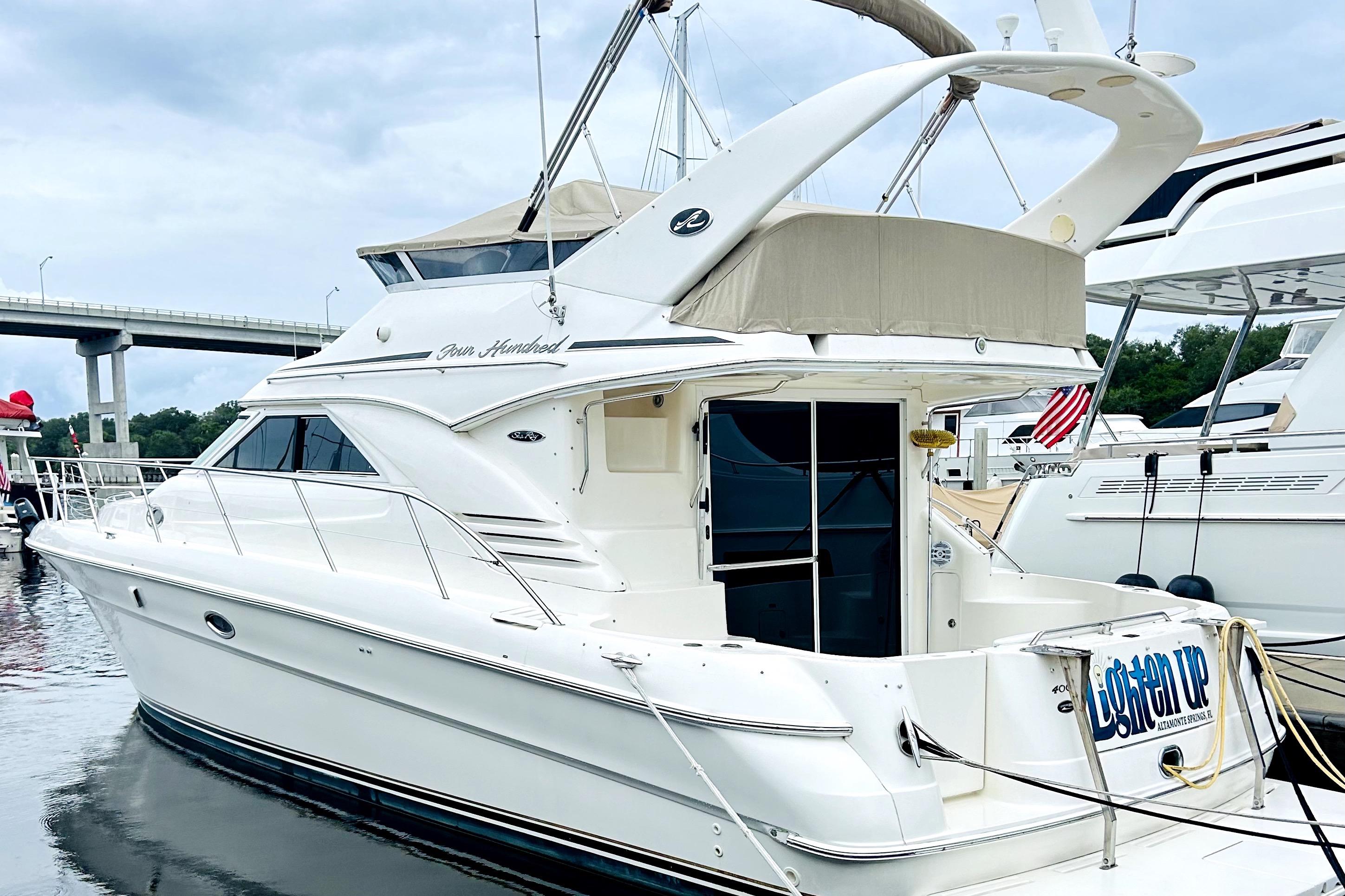 2003 Sea Ray 400 Sedan Bridge yacht docked at marina, featuring sleek design and spacious deck.