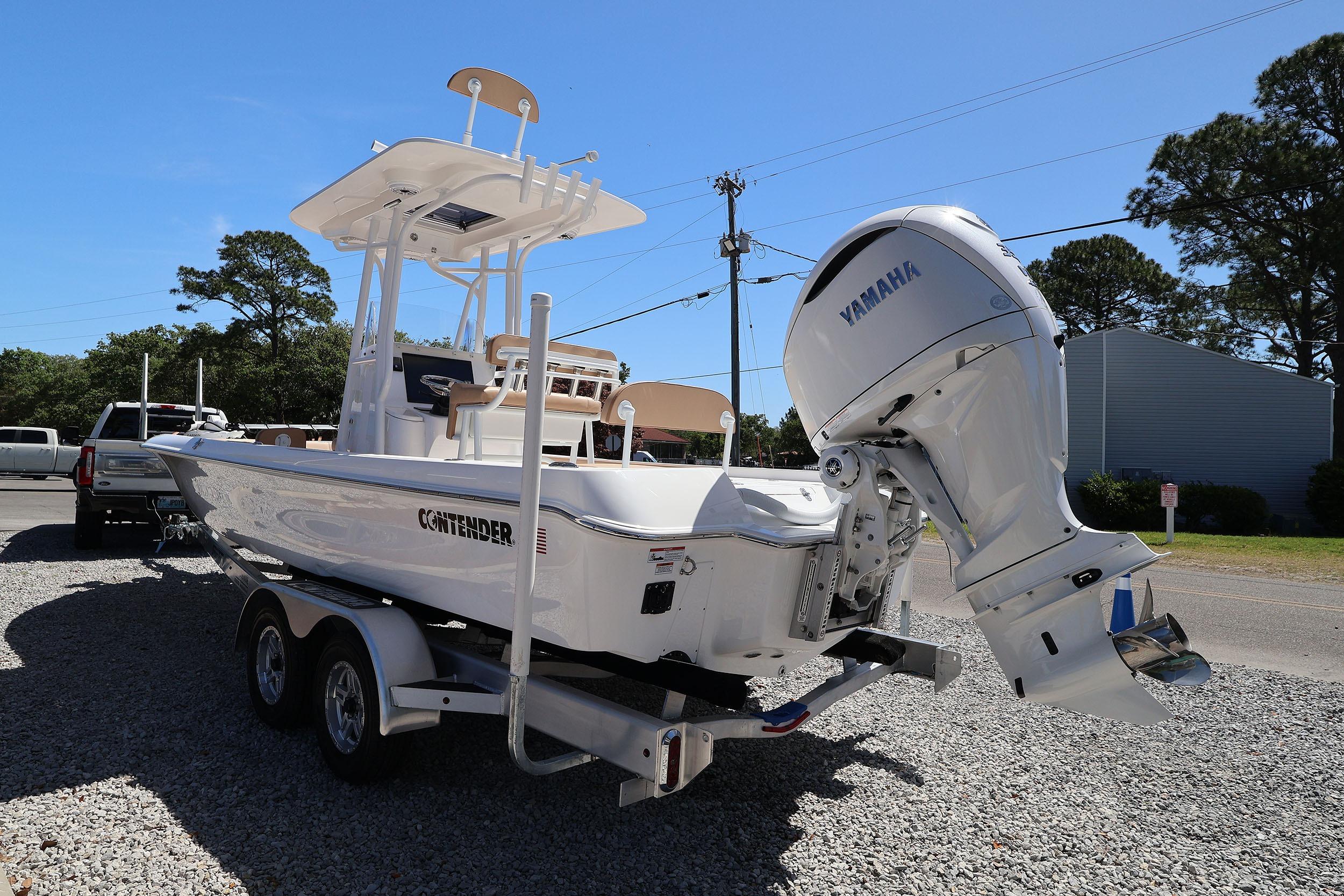 2026 Contender 26 Bay boat with Yamaha engine on trailer, parked outdoors.