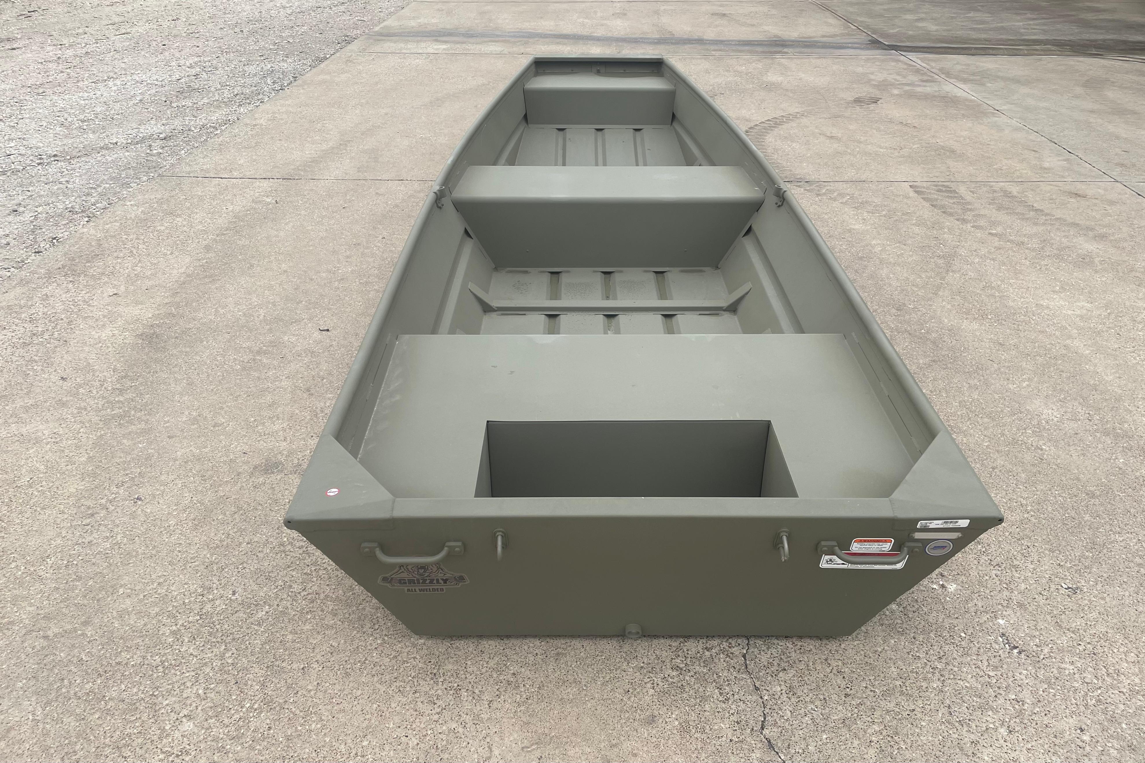 2026 Tracker Grizzly 14 Jon boat on concrete surface, showcasing its sturdy design.
