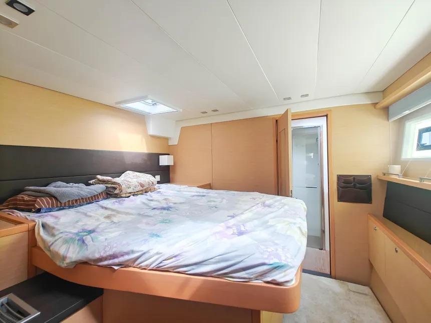 Luxurious cabin interior of 2012 Lagoon 560 yacht with cozy bed and modern design.