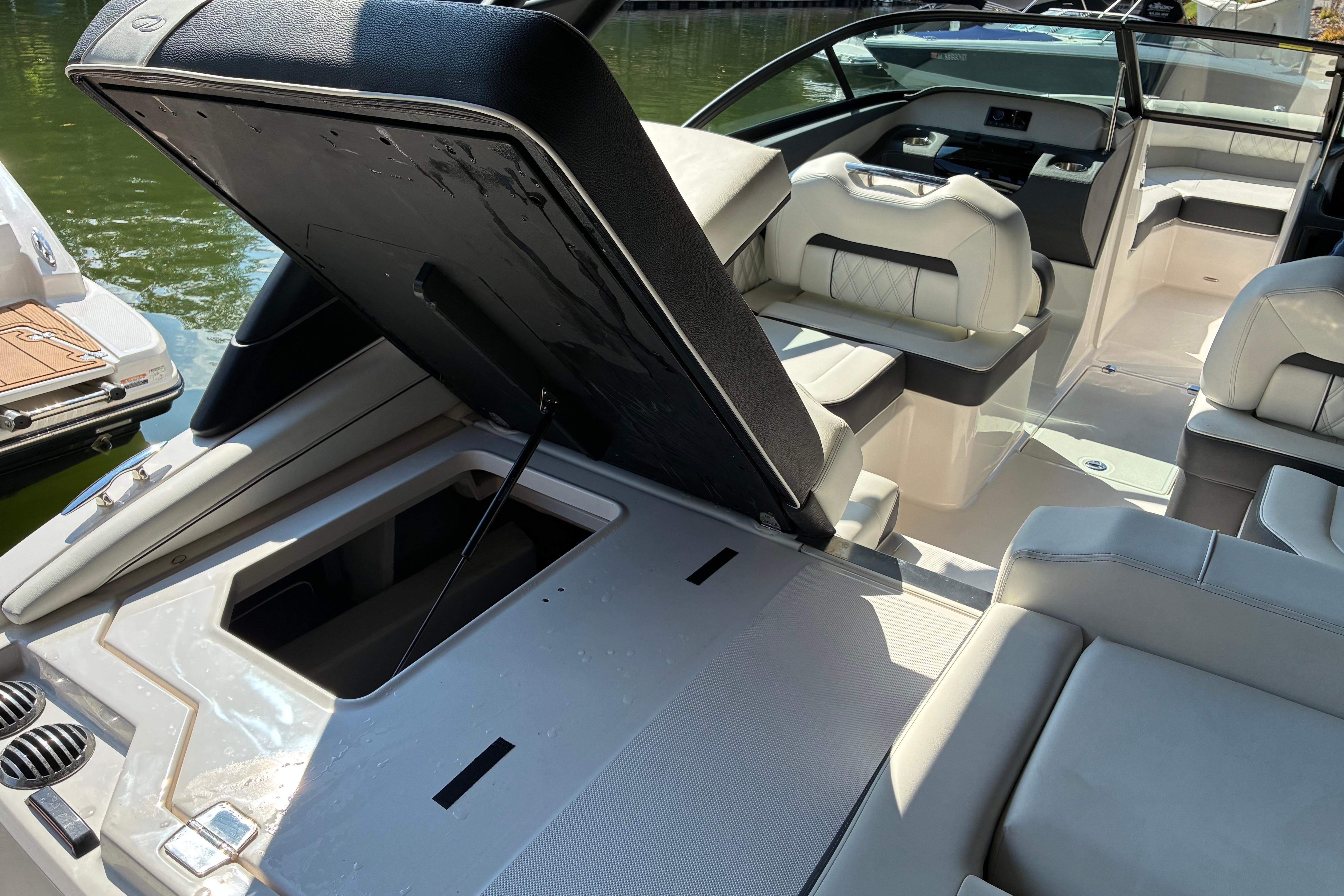 2025 Regal LS2 boat interior with open storage compartment, luxurious seating, and modern design.