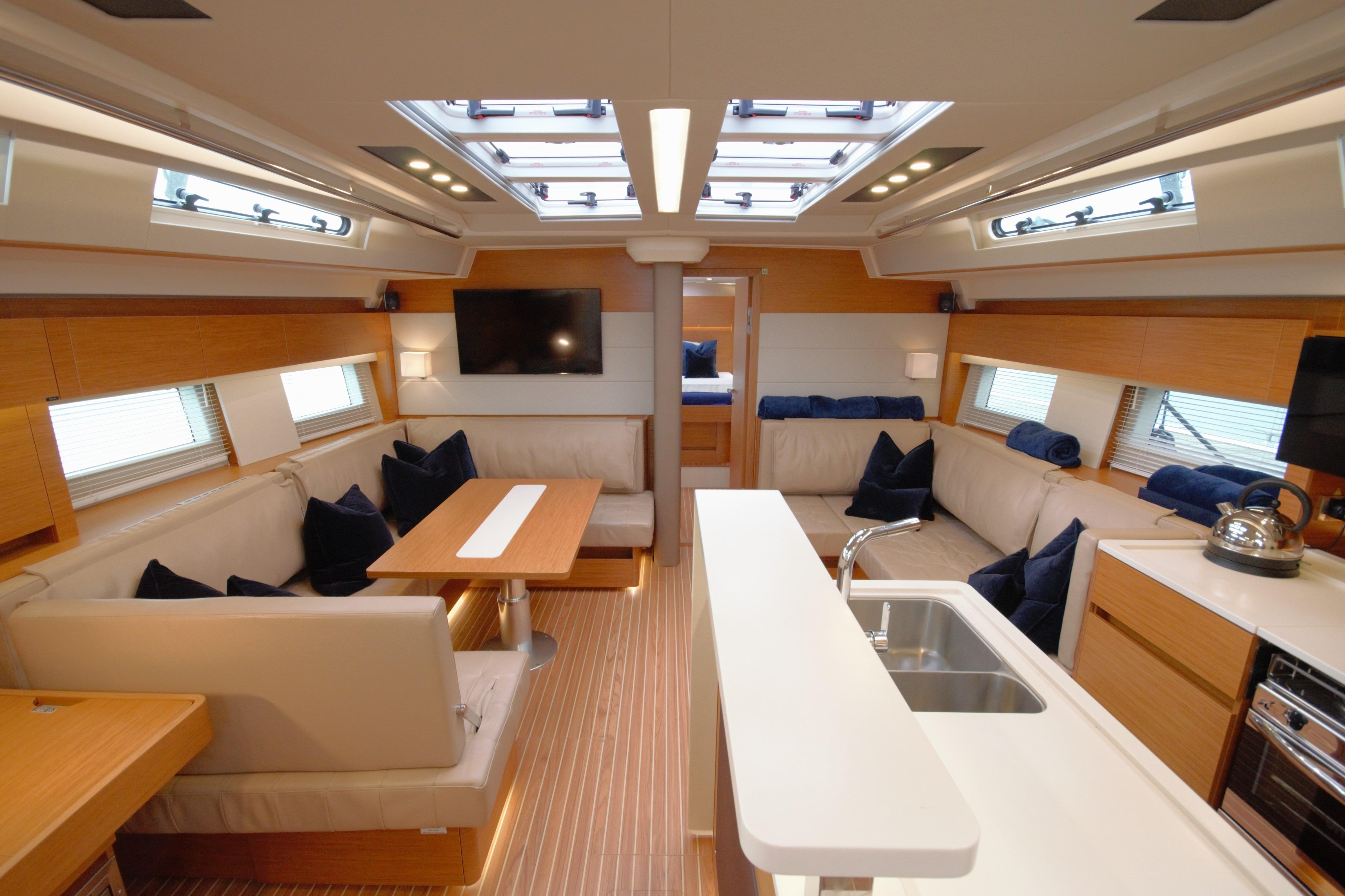 Luxurious interior of 2021 Hanse 588 yacht with modern furnishings and ample natural light.
