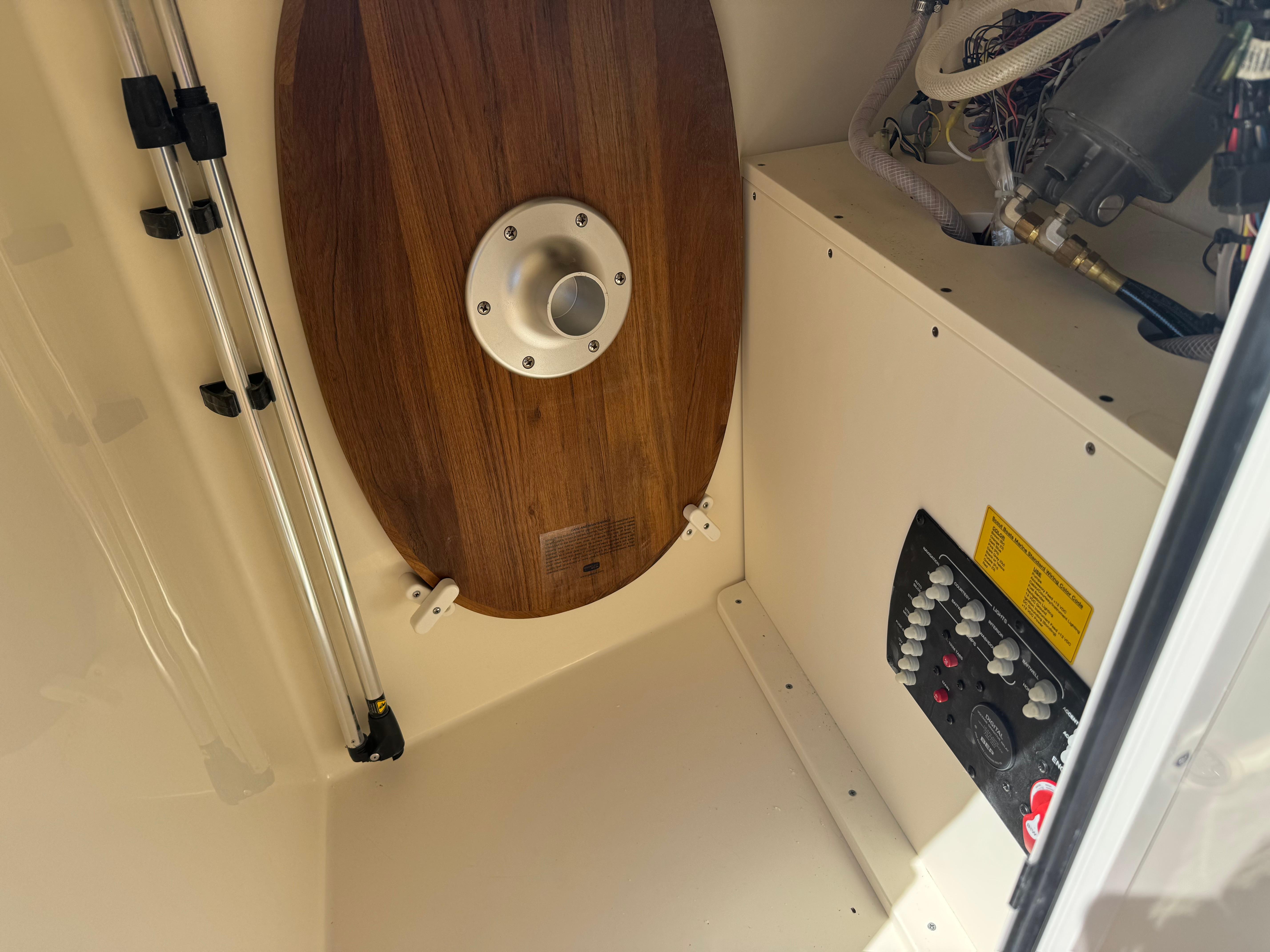 Interior view of 2025 Scout 215 Dorado boat, featuring control panel and wooden table.