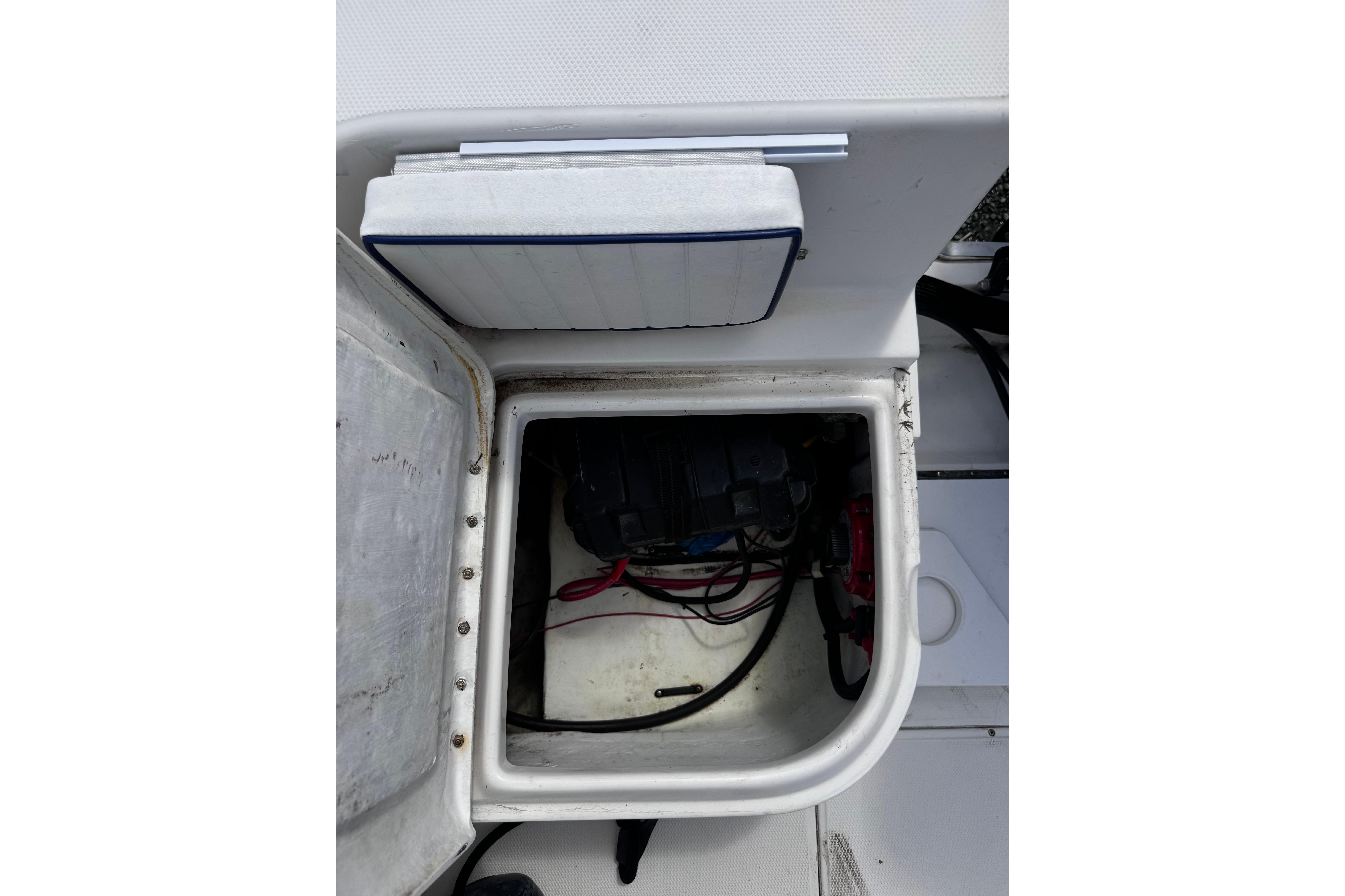 Open storage compartment in 2003 Palm Beach 2200 Dual Console boat, showing wiring and equipment.