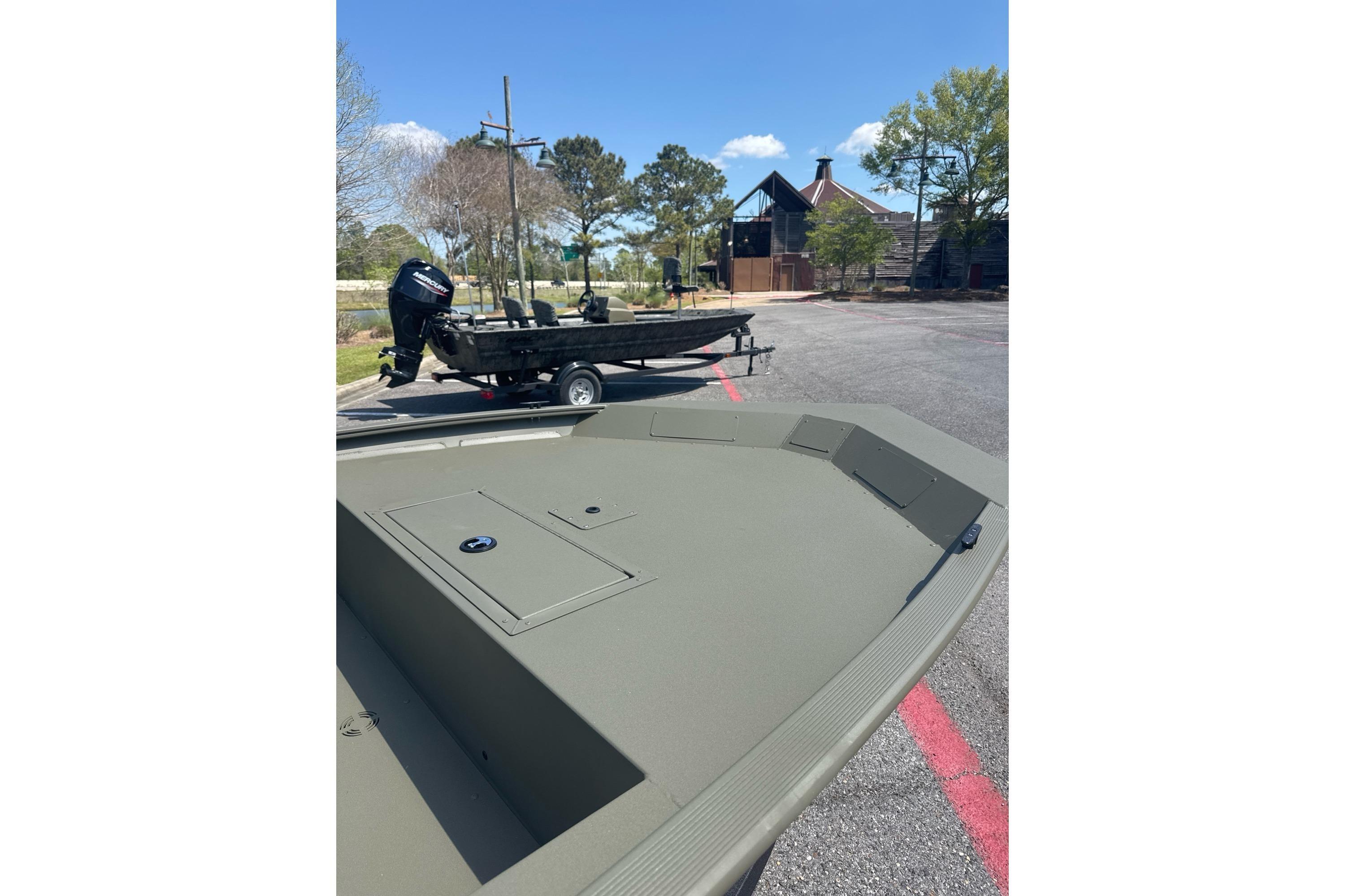 2026 Tracker Grizzly 1754 Utility boat on trailer in sunny parking lot.