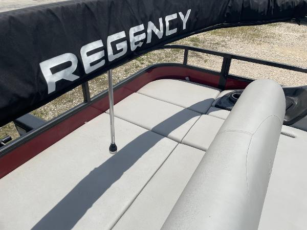2023 Regency 250 DL3 boat with cushioned seating and protective cover.