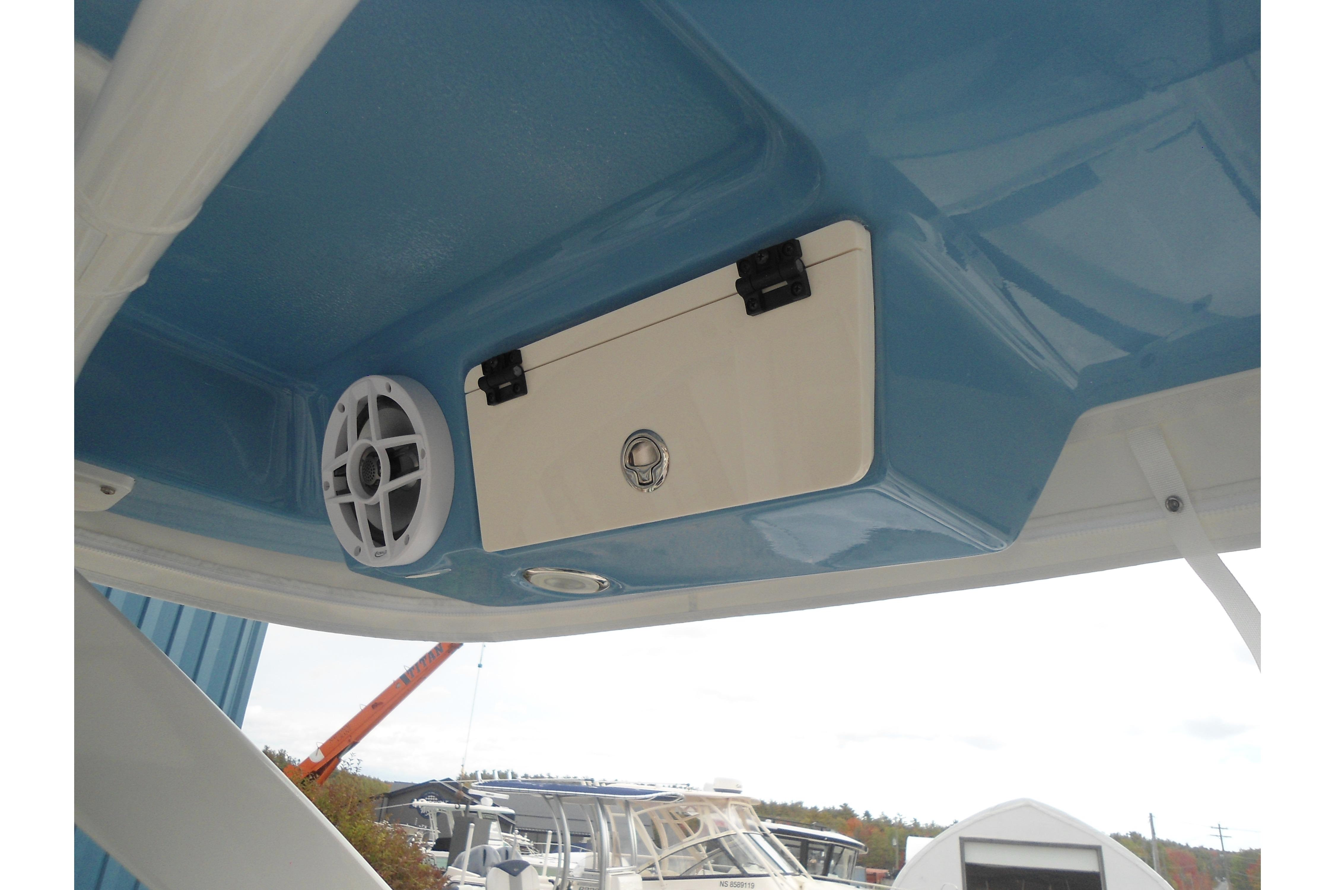 2026 Robalo R257 Dual Console boat interior with speaker and storage compartment.