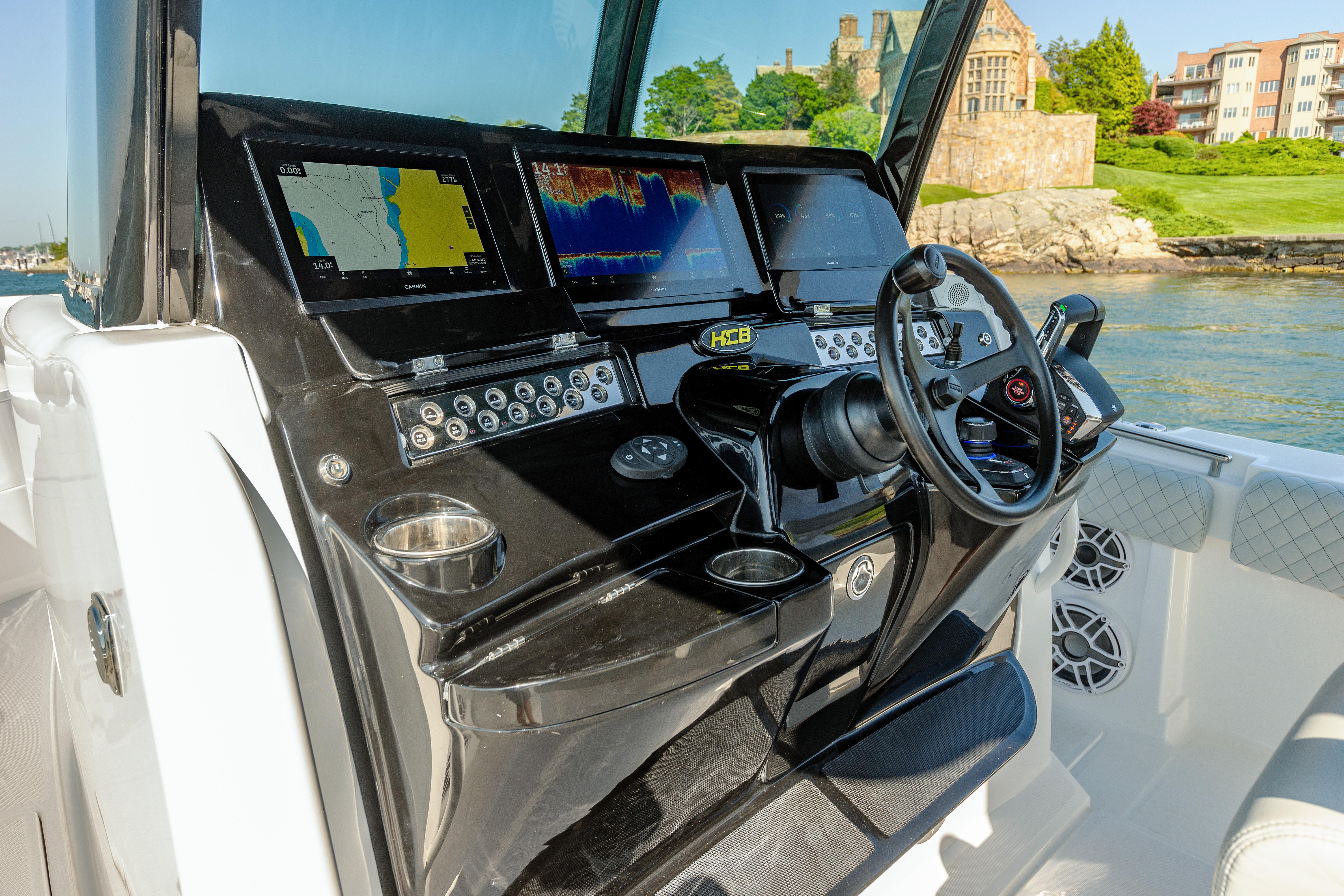 HCB 39 Speciale 2024 boat dashboard with navigation screens and steering wheel.