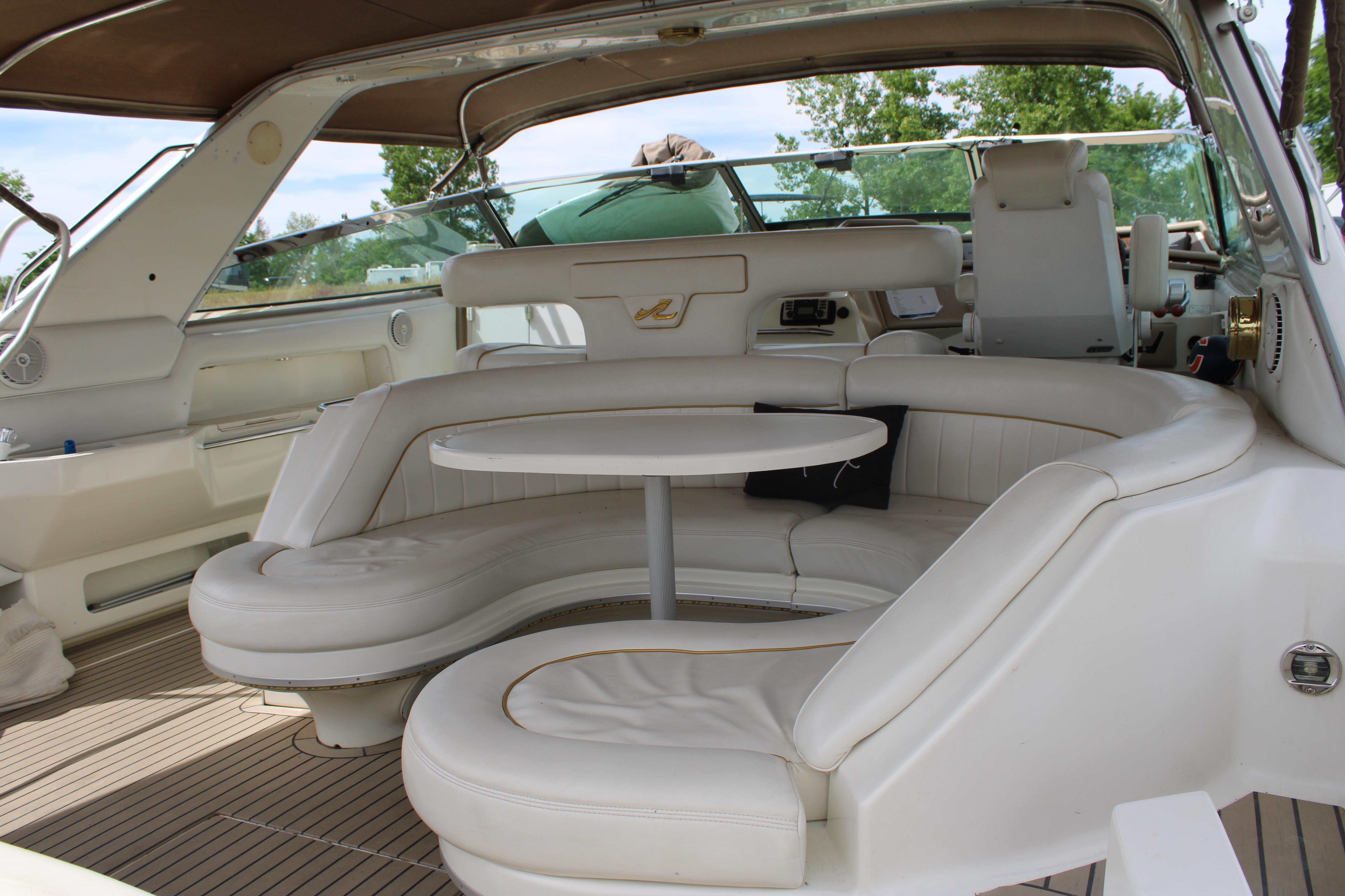 Luxurious interior of a 1995 Sea Ray 500 Sundancer yacht with plush seating and table.