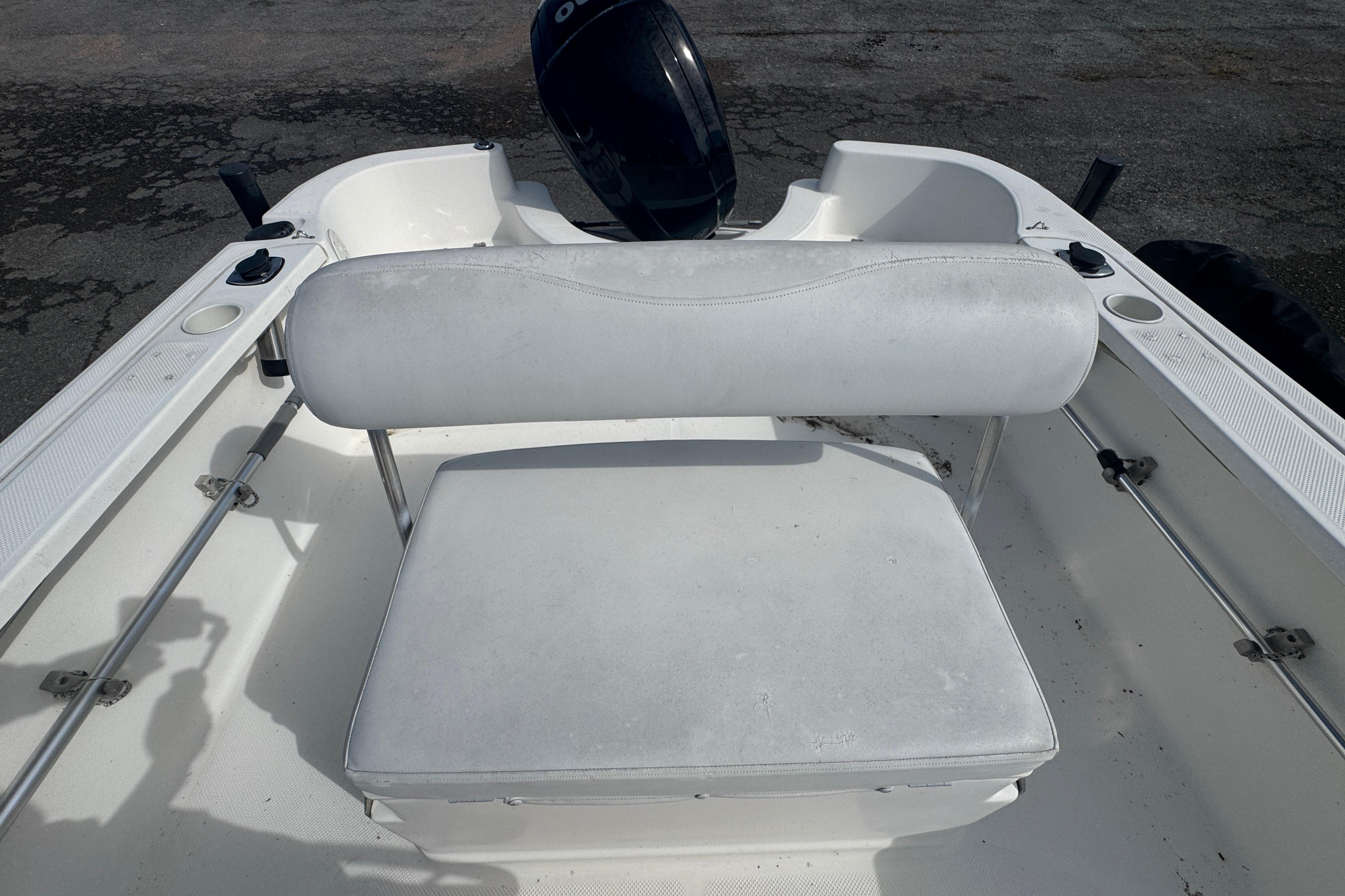 2007 Trophy 1703 Center Console boat interior with white seating and motor.