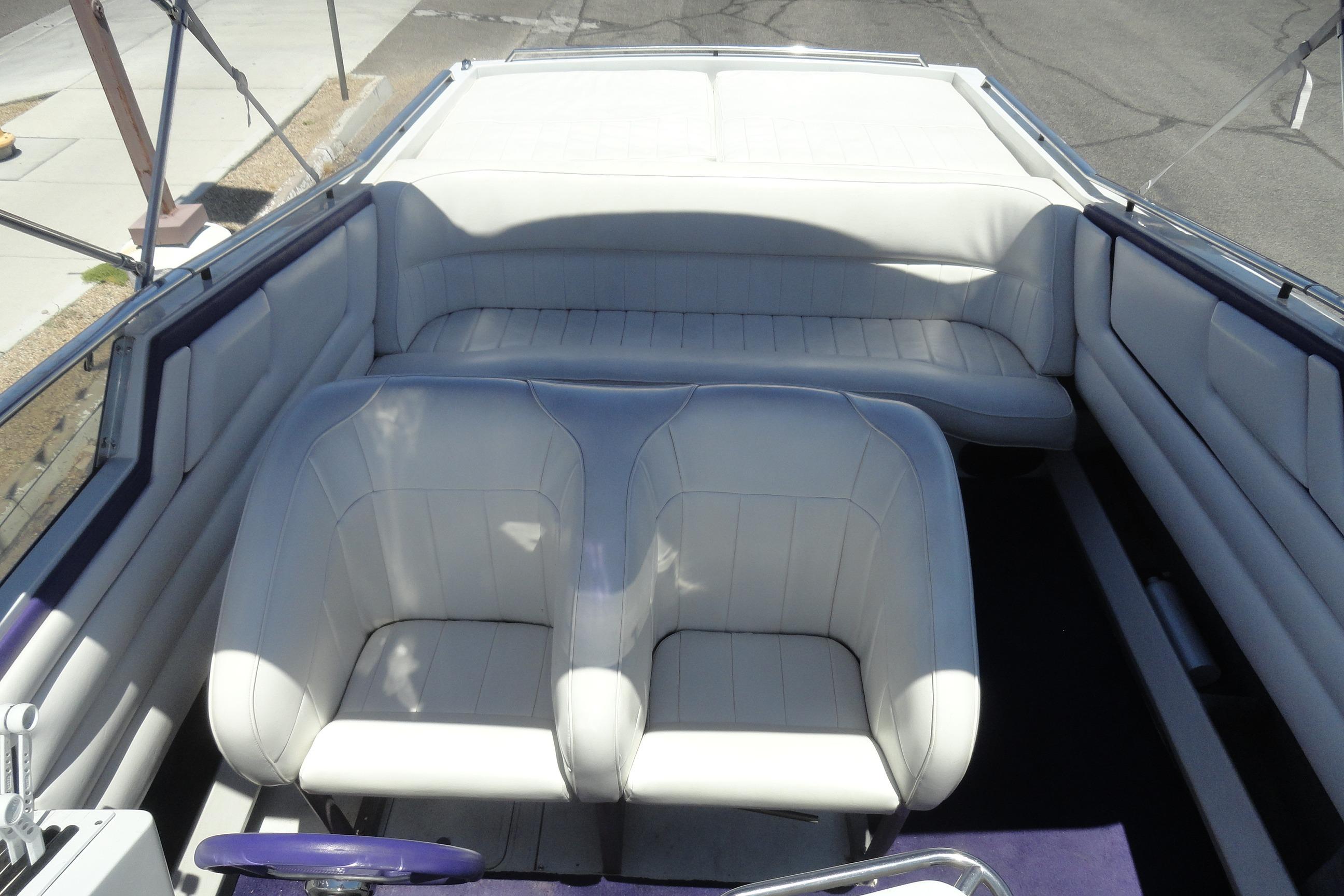 Interior of a 1988 Wellcraft 34 Scarab boat with white seating and steering wheel.