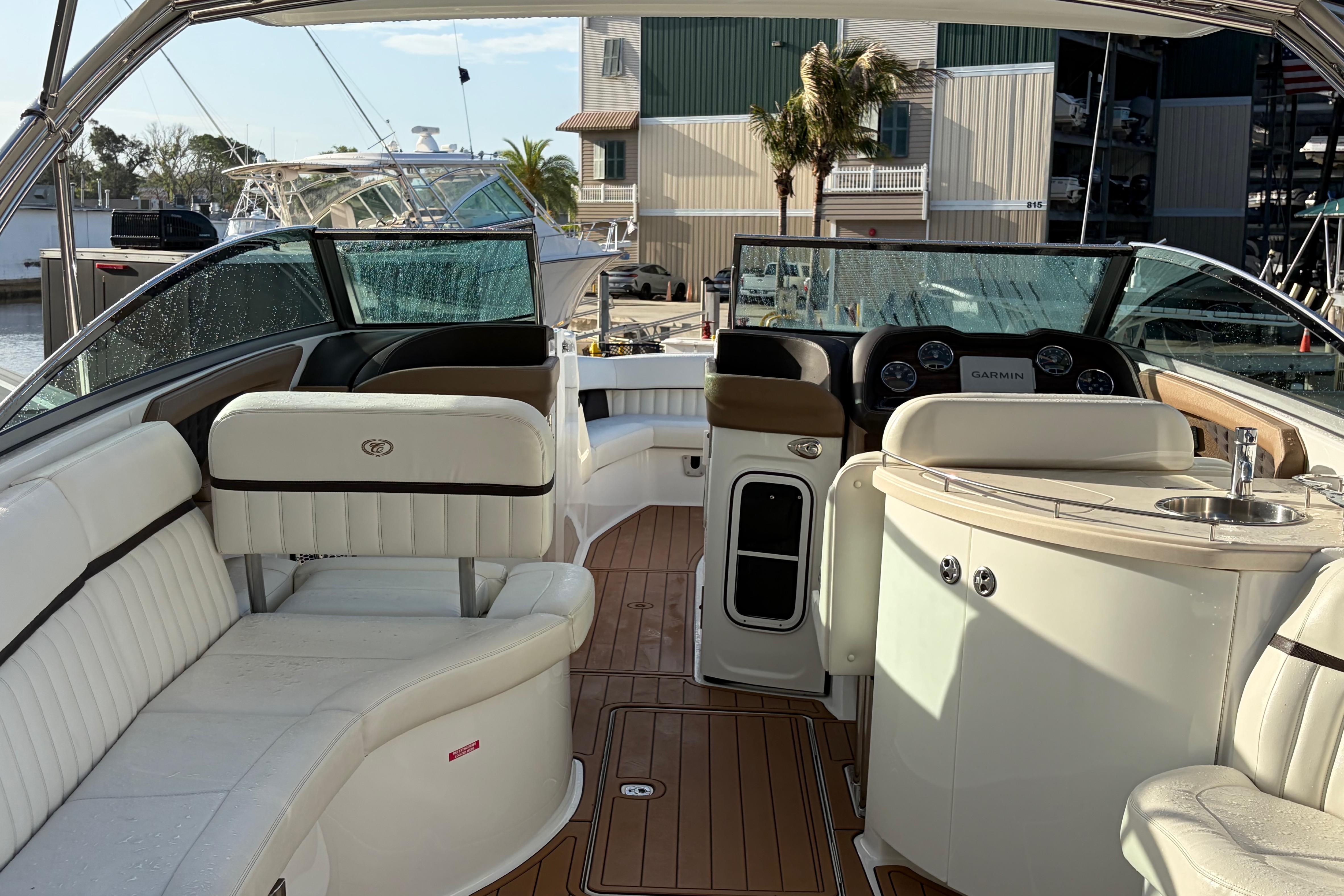 Luxurious interior of a 2015 Cobalt 336 boat with leather seating and modern dashboard.