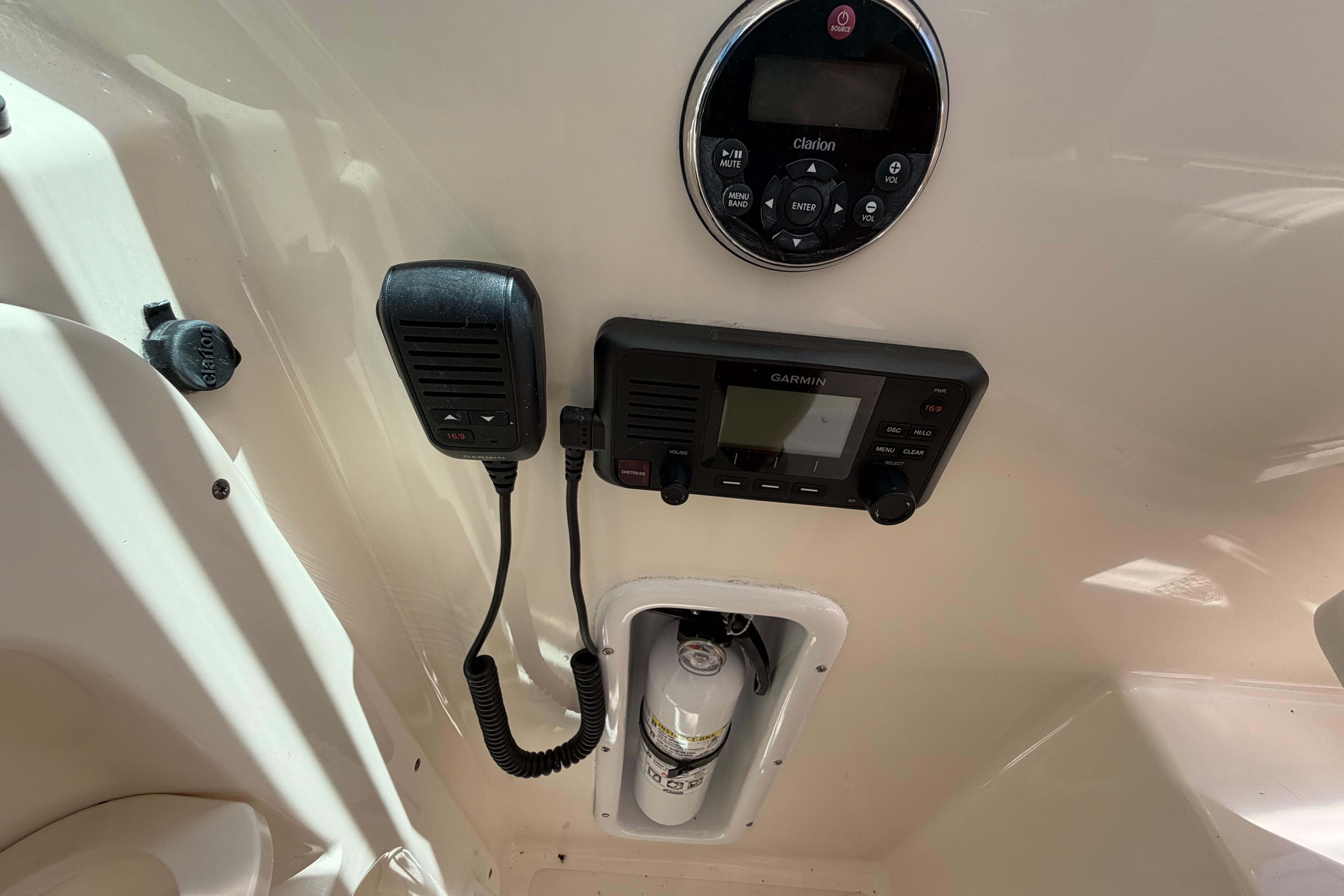 2010 Pursuit OS 255 Offshore boat dashboard with Clarion and Garmin electronics.