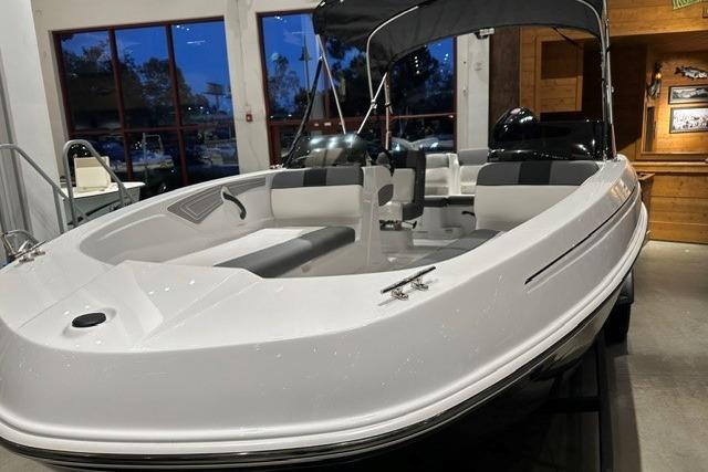 2026 Tahoe T21 boat displayed indoors with sleek white design and modern seating.