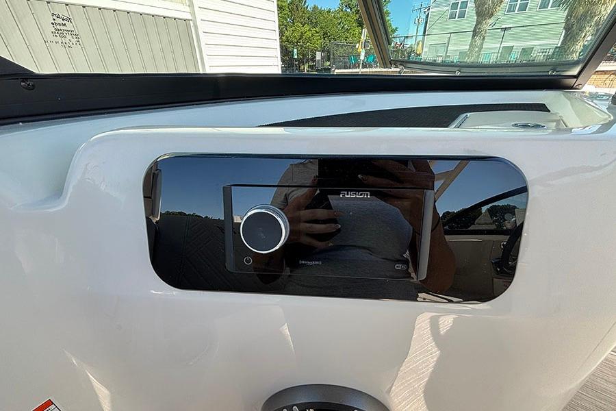 2027 Sea Ray SDX 230 Outboard dashboard with Fusion audio system.