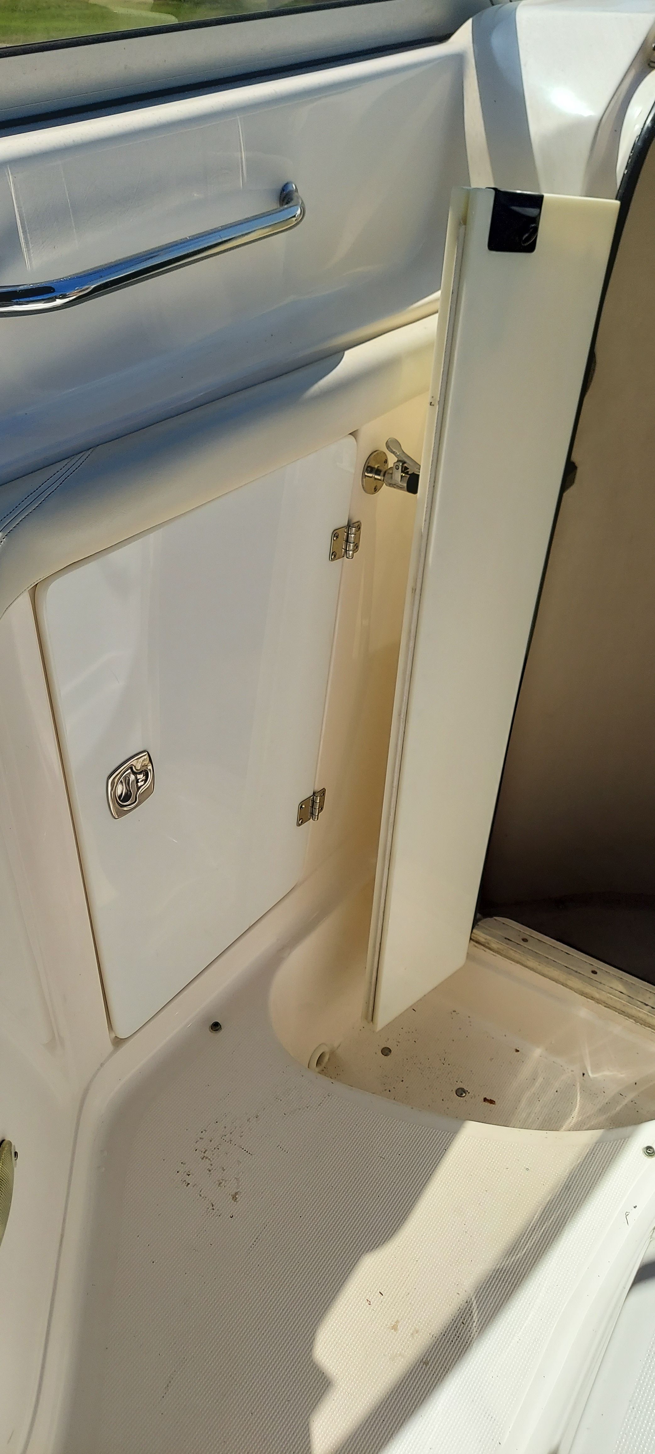 Interior of a 2004 Regal Commodore 2465 with open storage compartment door.