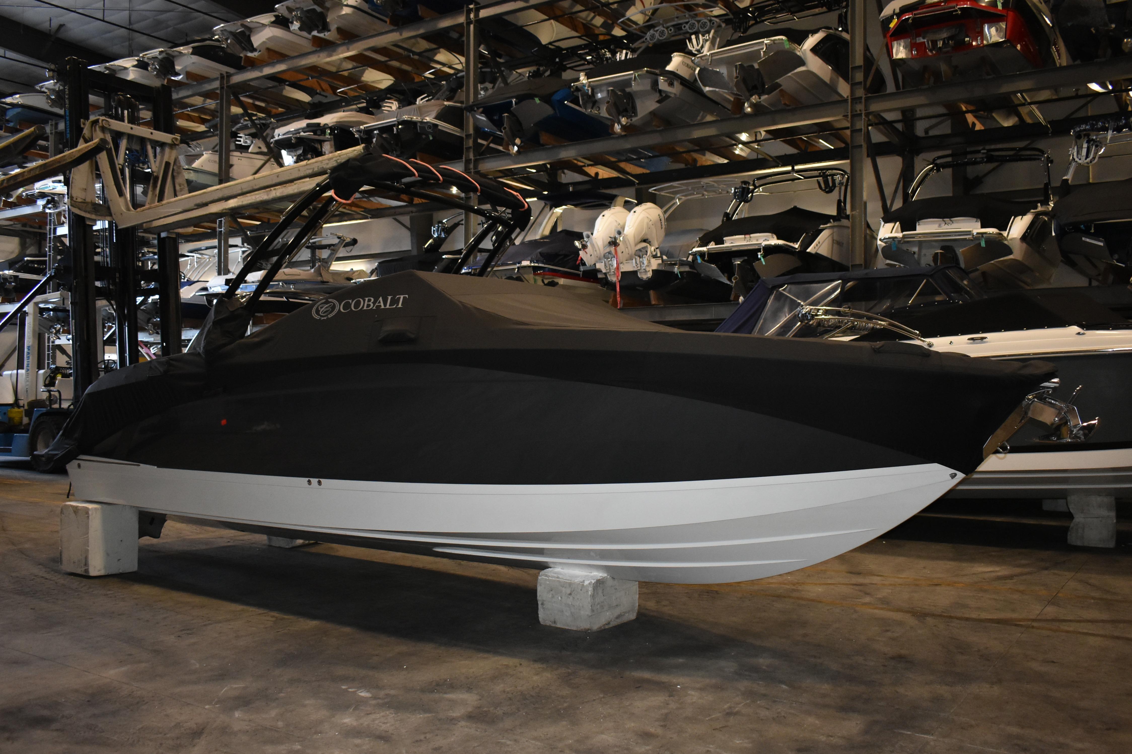2023 Cobalt R8 boat in storage, covered and elevated on blocks.