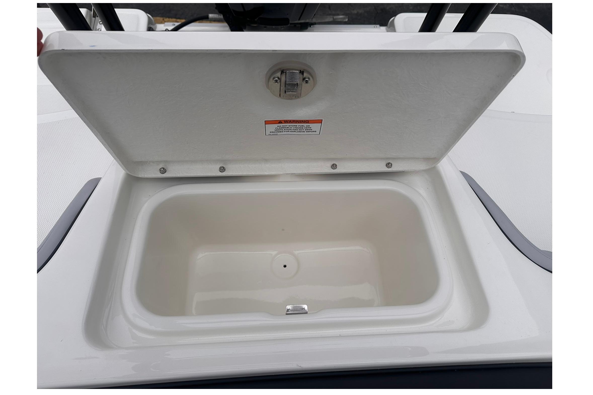 Open storage compartment on 2026 Bayliner M17 boat, showcasing interior space.