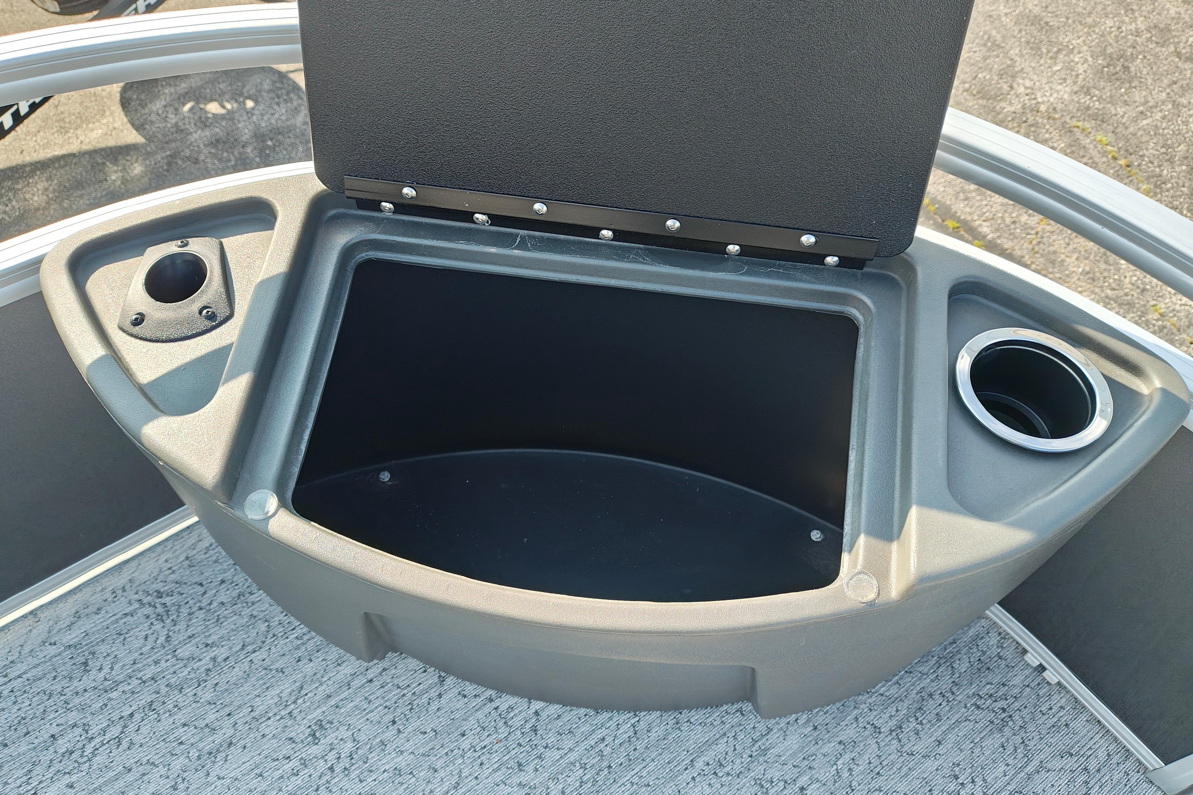 Storage compartment on 2026 Sun Tracker Bass Buggy 18 DLX boat with cup holders.