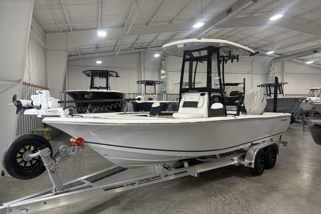 2026 Tidewater 2300 Carolina Bay boat on trailer in indoor showroom.