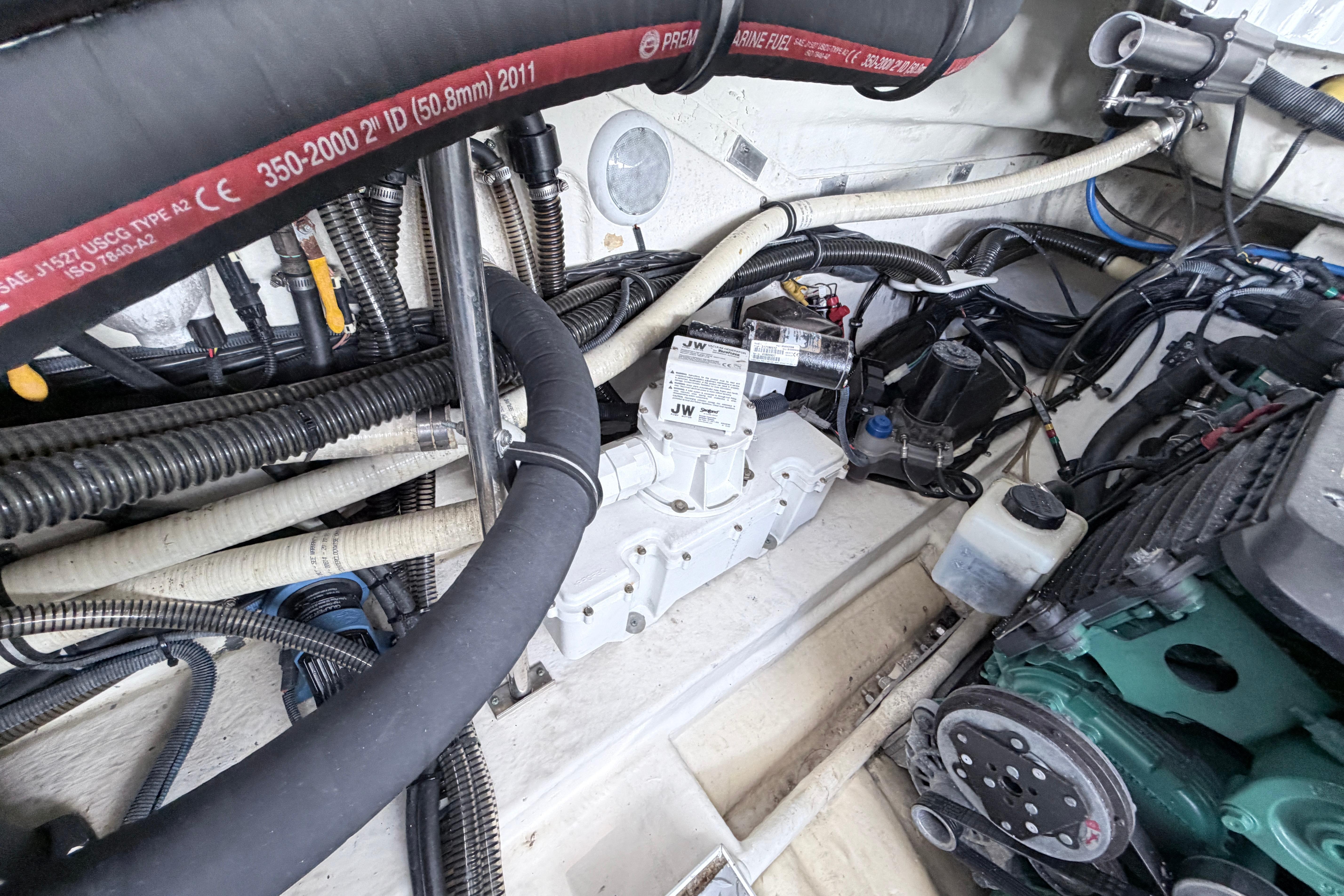 Engine compartment of a 2015 Formula 350 Crossover Bowrider with visible hoses and wiring.