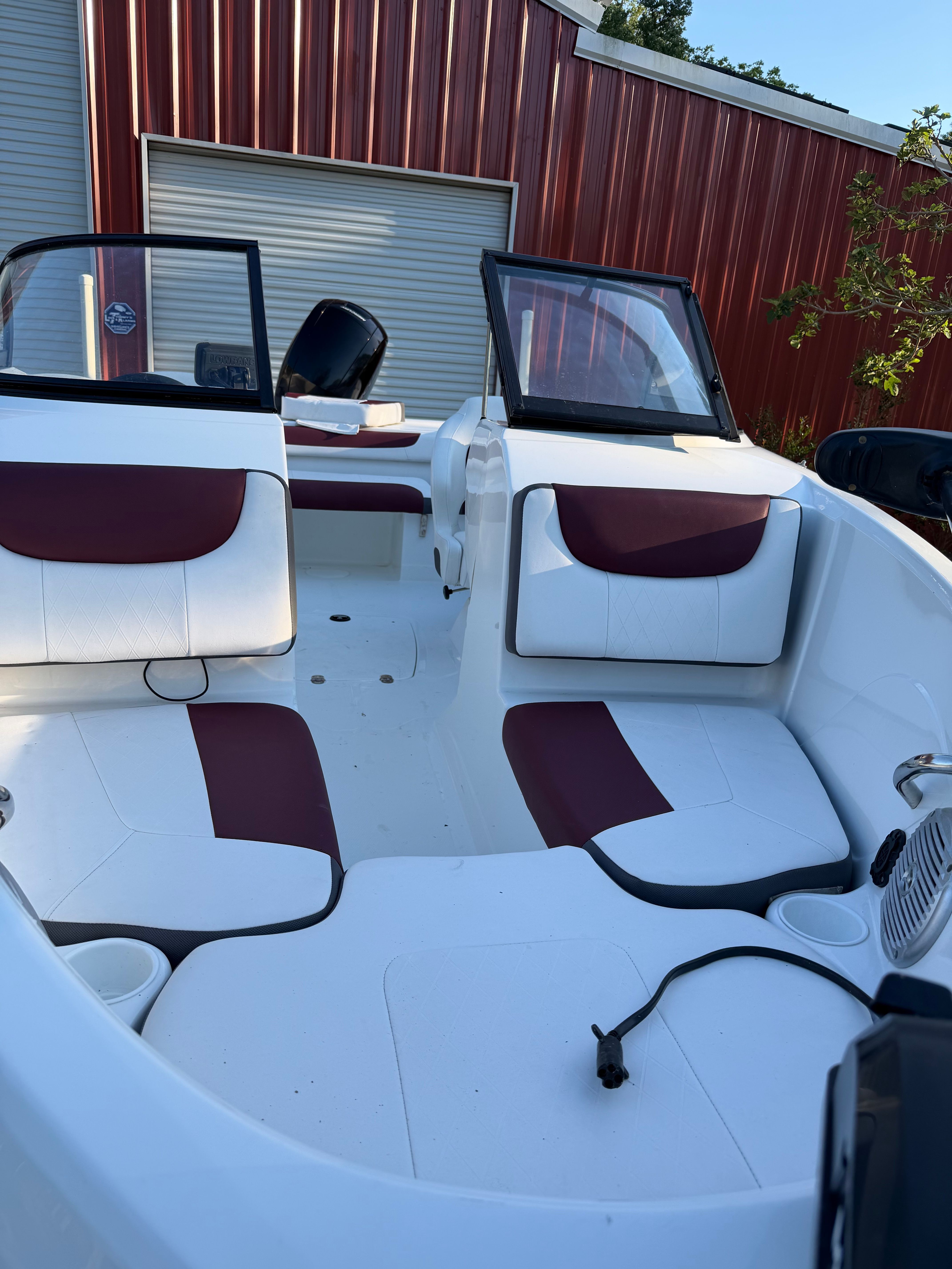 Interior of a 2020 Tracker Tahoe 550TF boat with red and white seating.