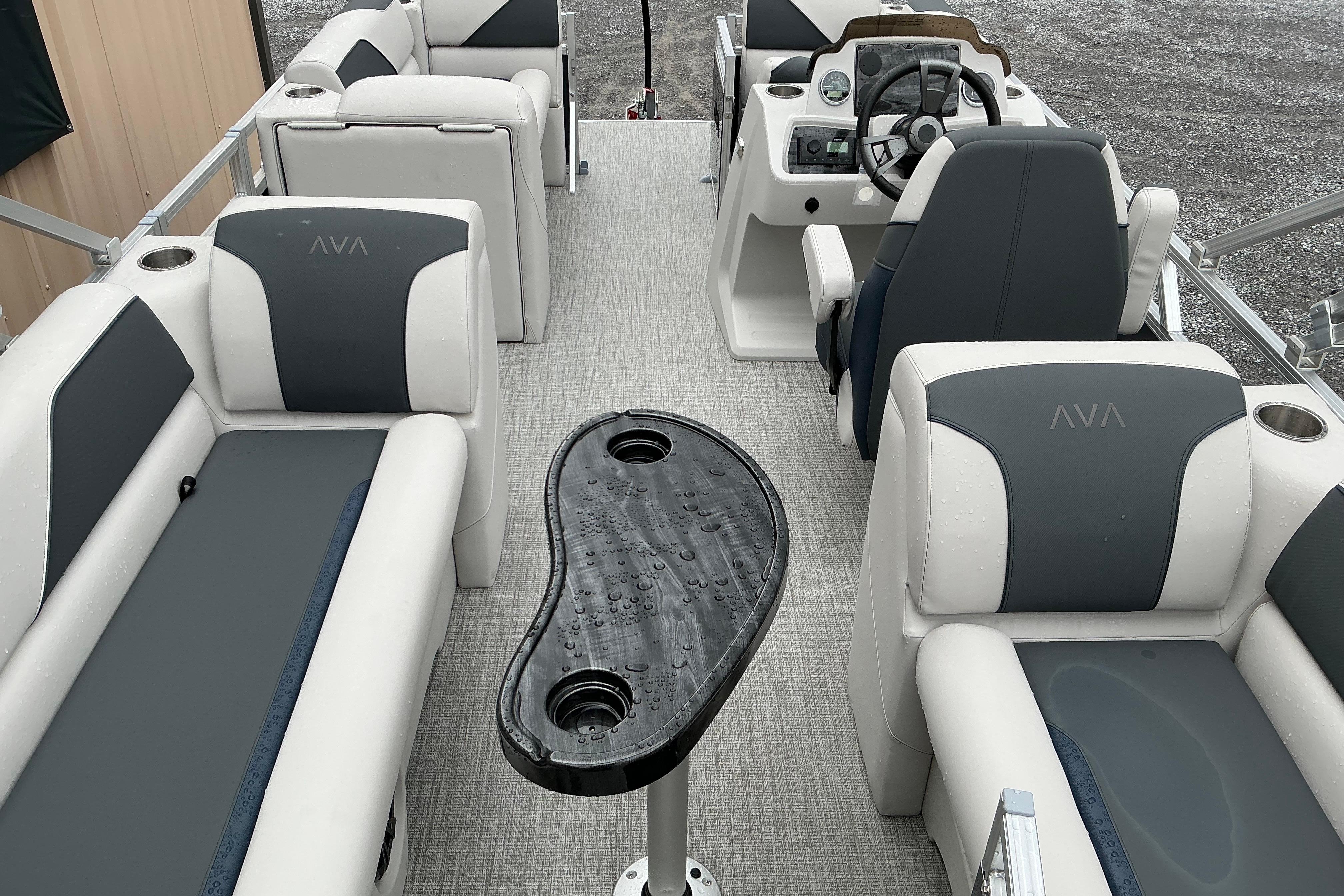 2026 Avalon Venture Quad Lounge boat interior with gray seating and a central table.