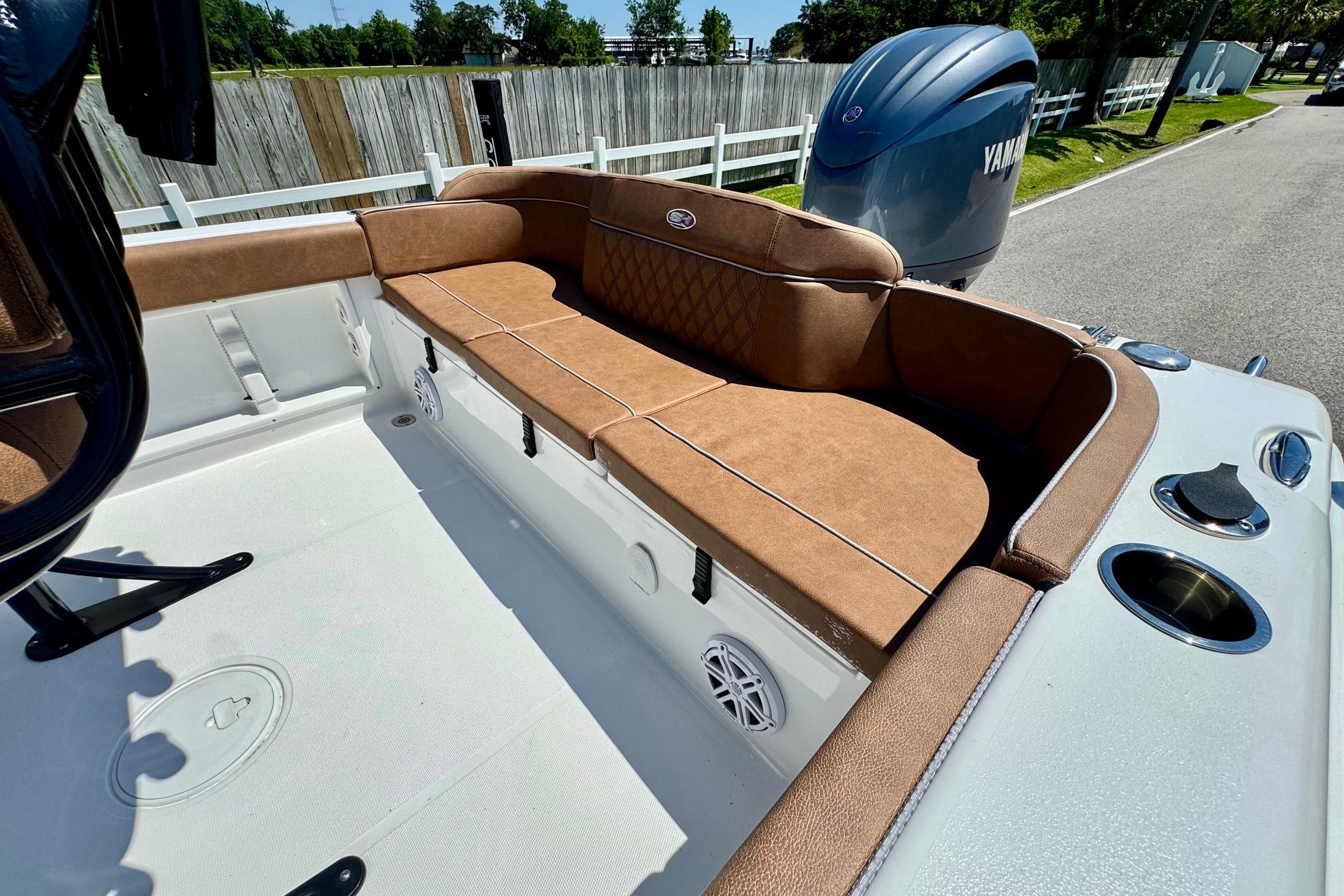 2025 Sea Hunt Ultra 219 boat with brown cushioned seating and Yamaha engine.