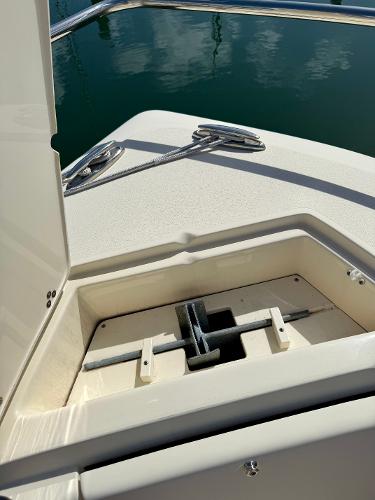 2016 Scout 245 Dorado boat anchor compartment with cleats, docked on calm water.