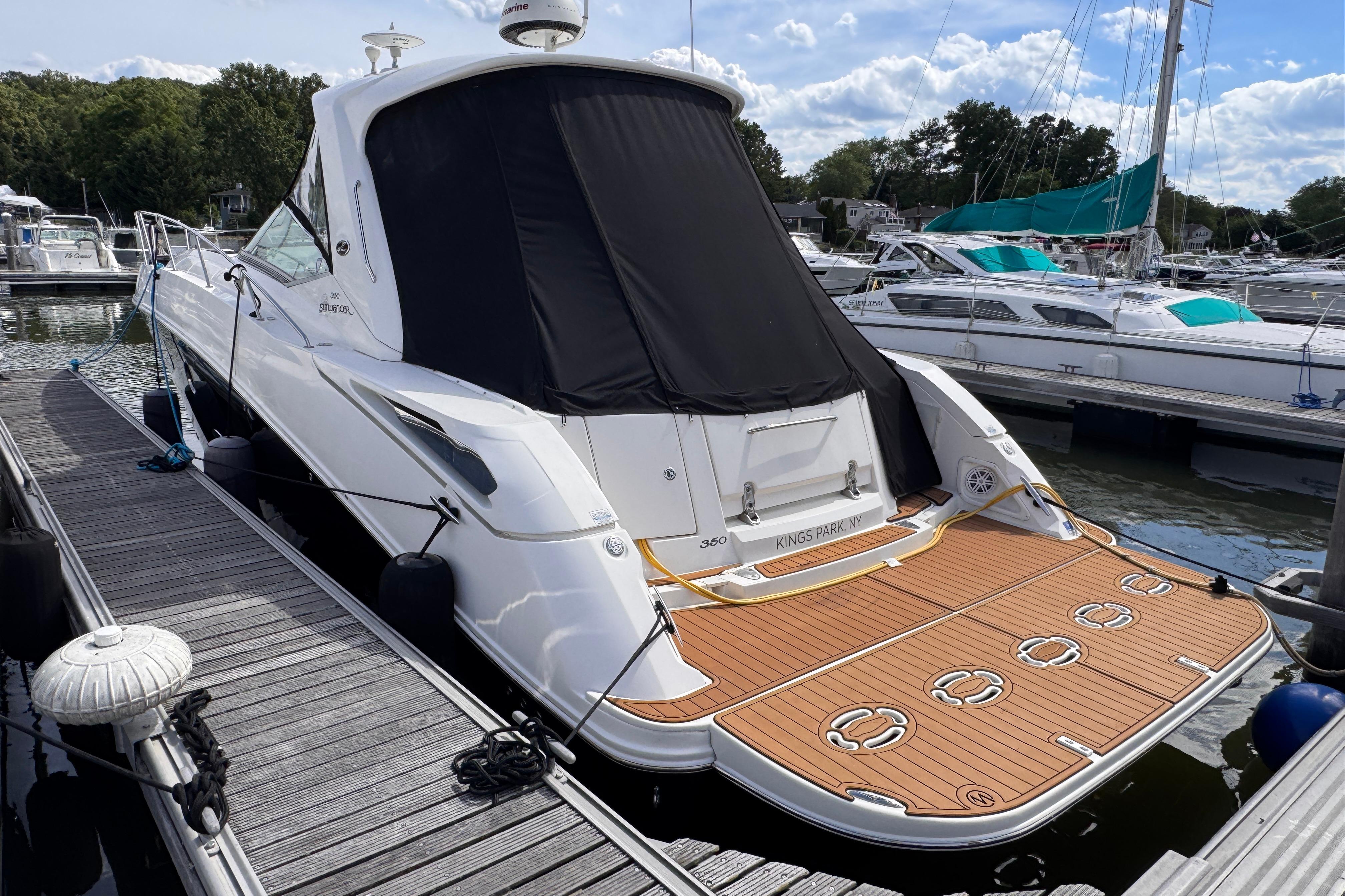2008 Sea Ray Sundancer 350 docked at marina, featuring sleek design and spacious deck.