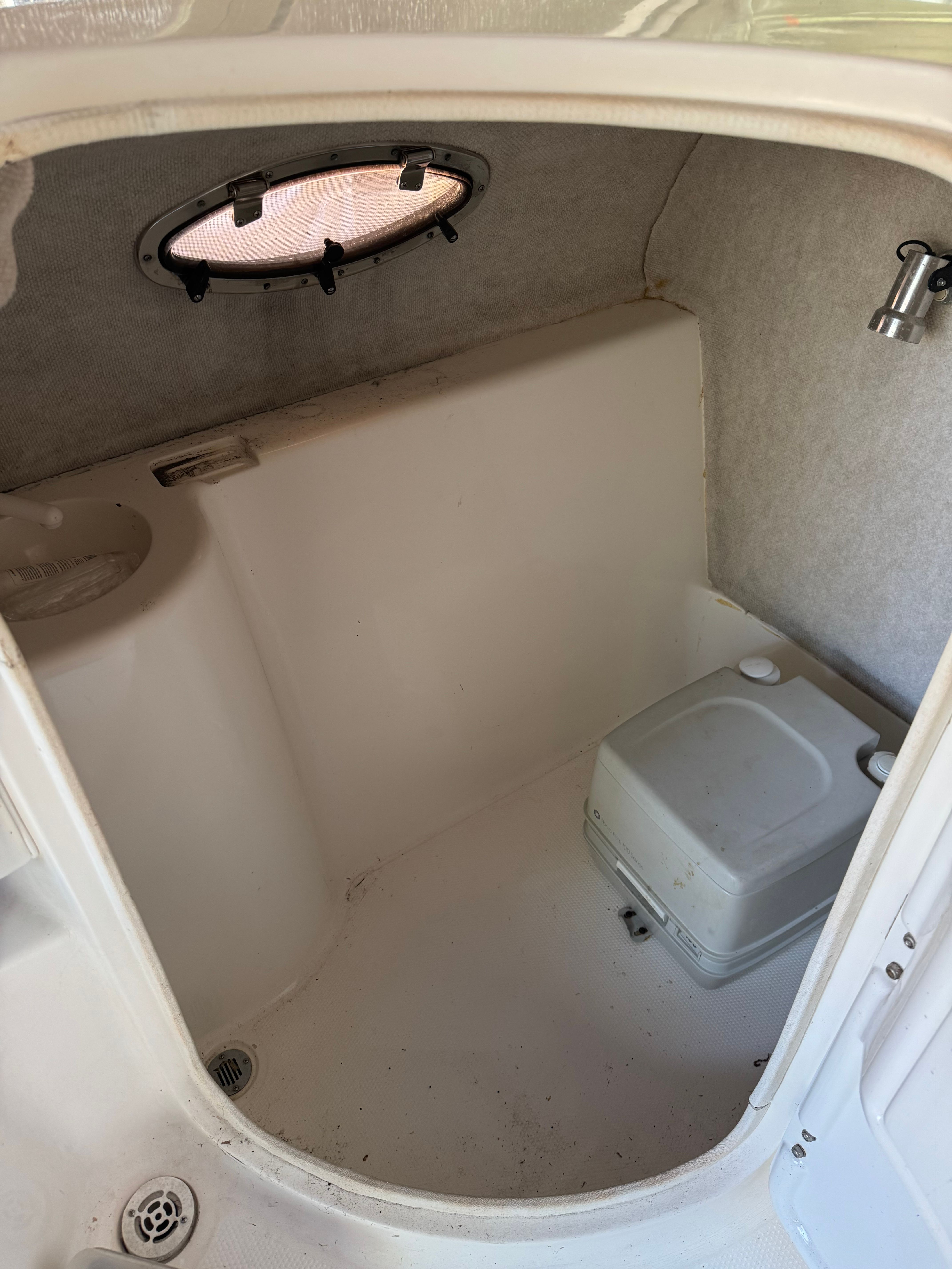 Interior of a boat cabin with a toilet and sink.