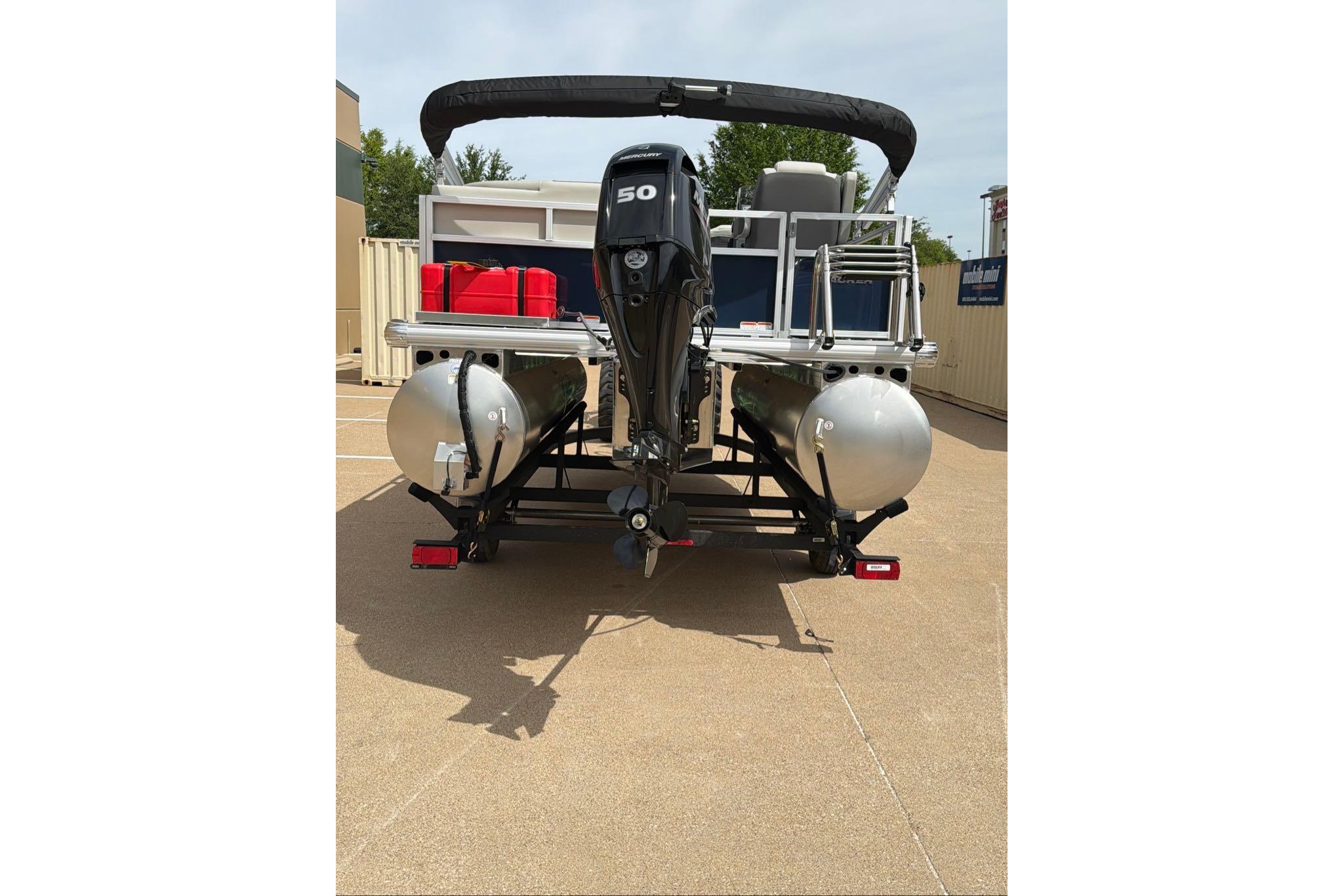 2026 Sun Tracker Bass Buggy 16 XL Select pontoon boat, rear view with motor and pontoons.