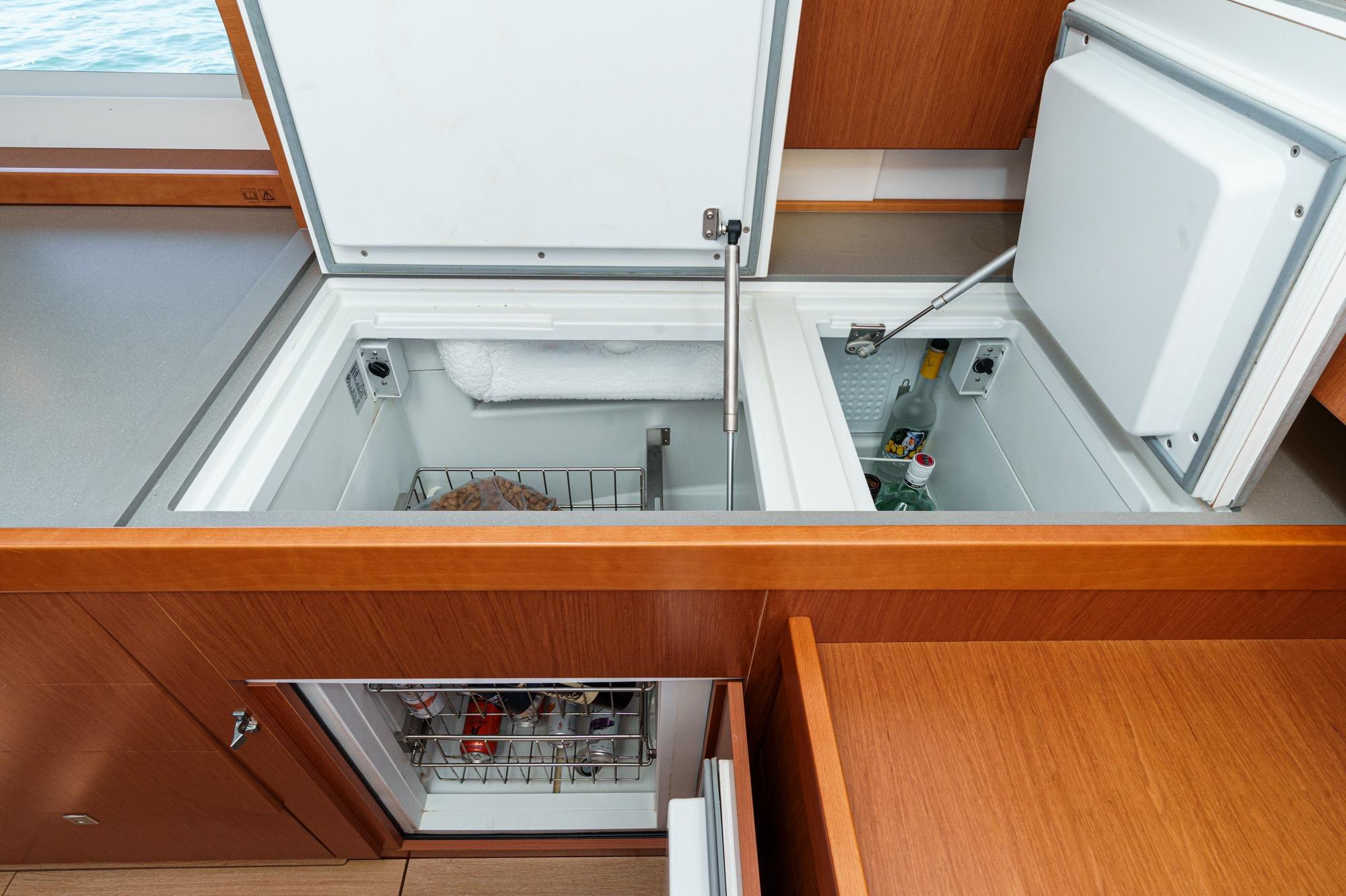Spacious kitchen storage on 2017 Beneteau Sense 50 yacht, featuring dual compartment refrigeration.