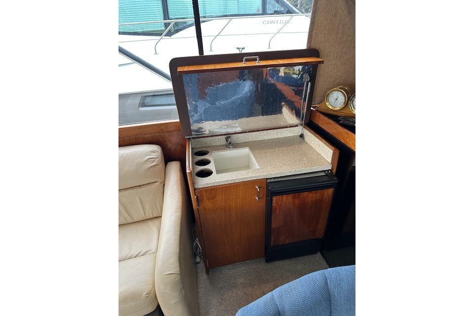 1988 Ocean 44' Super Sport yacht interior with sink and mini-fridge.