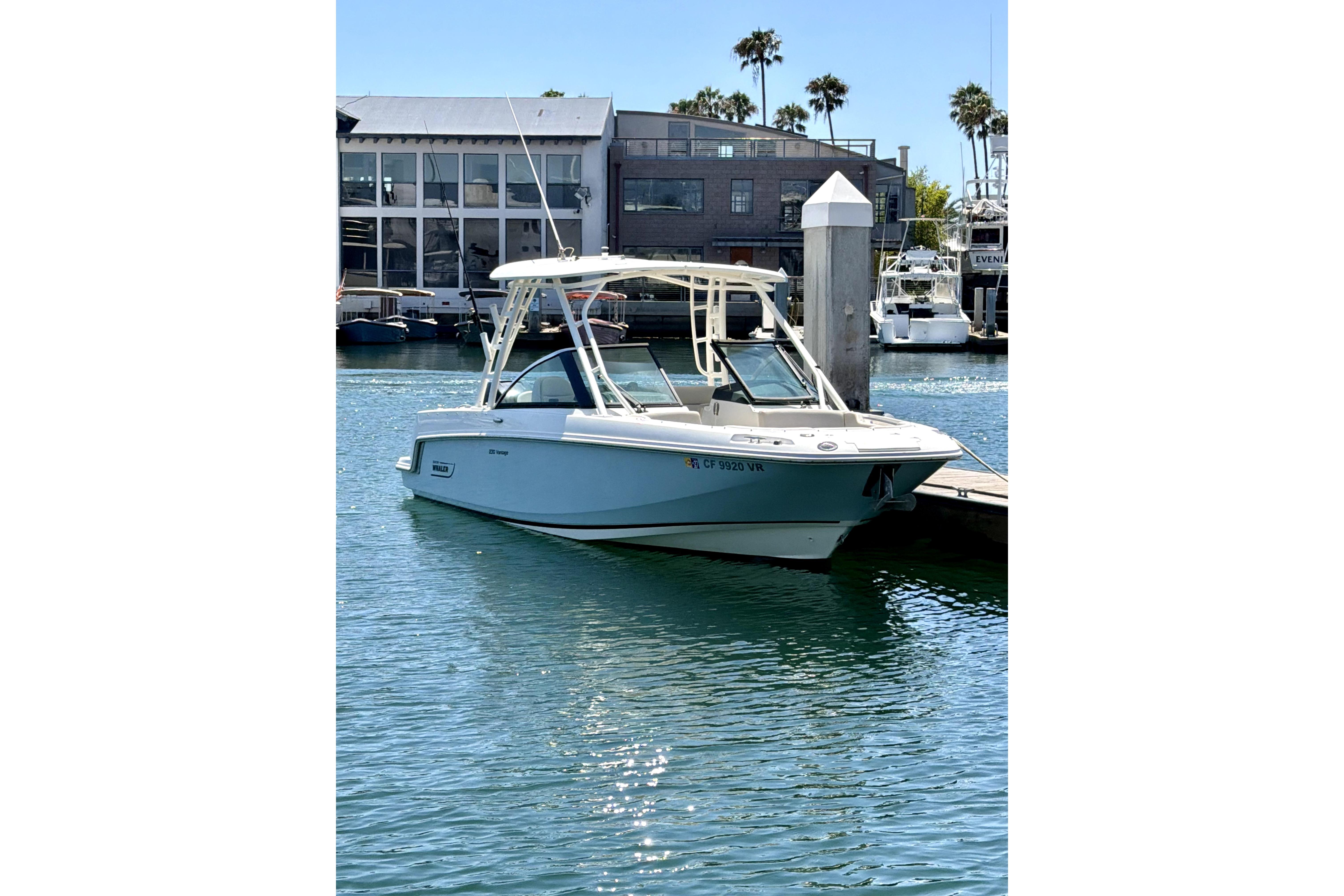 2017 Boston Whaler 230 Vantage docked in a sunny marina setting.