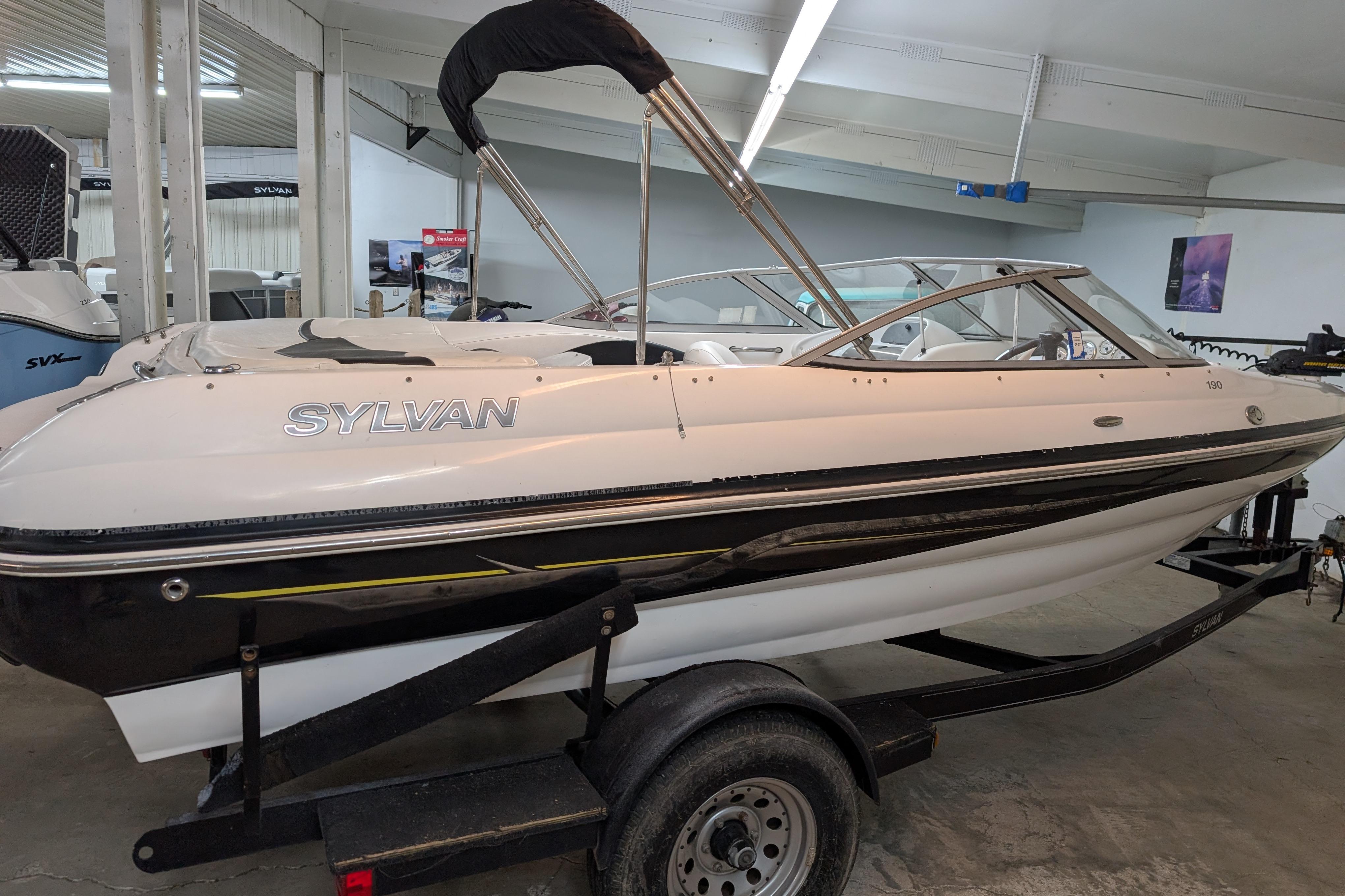 2005 Sylvan V190 I/O boat on trailer in indoor showroom.