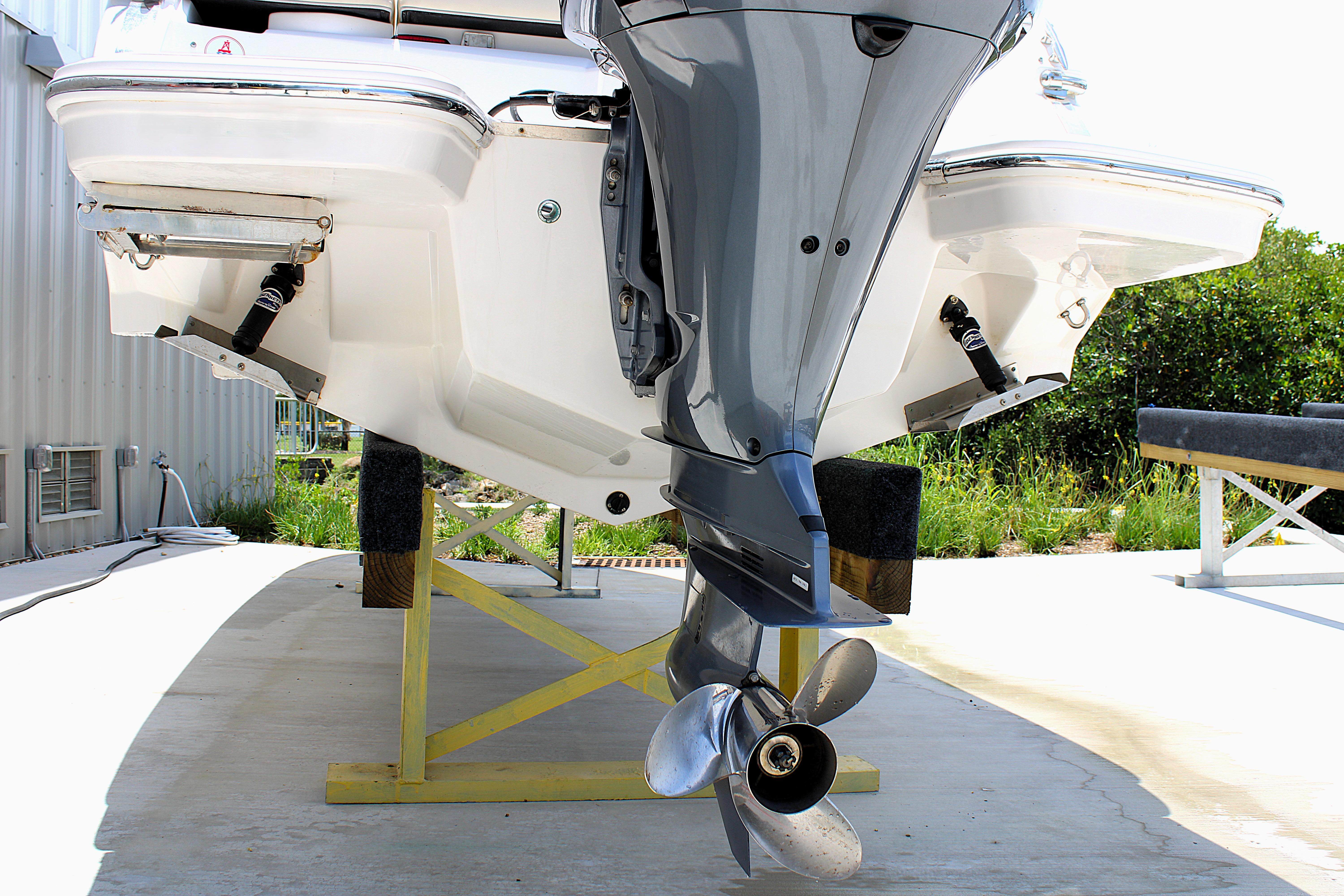 2021 Regal 26 OBX boat with outboard motor on a stand, rear view.