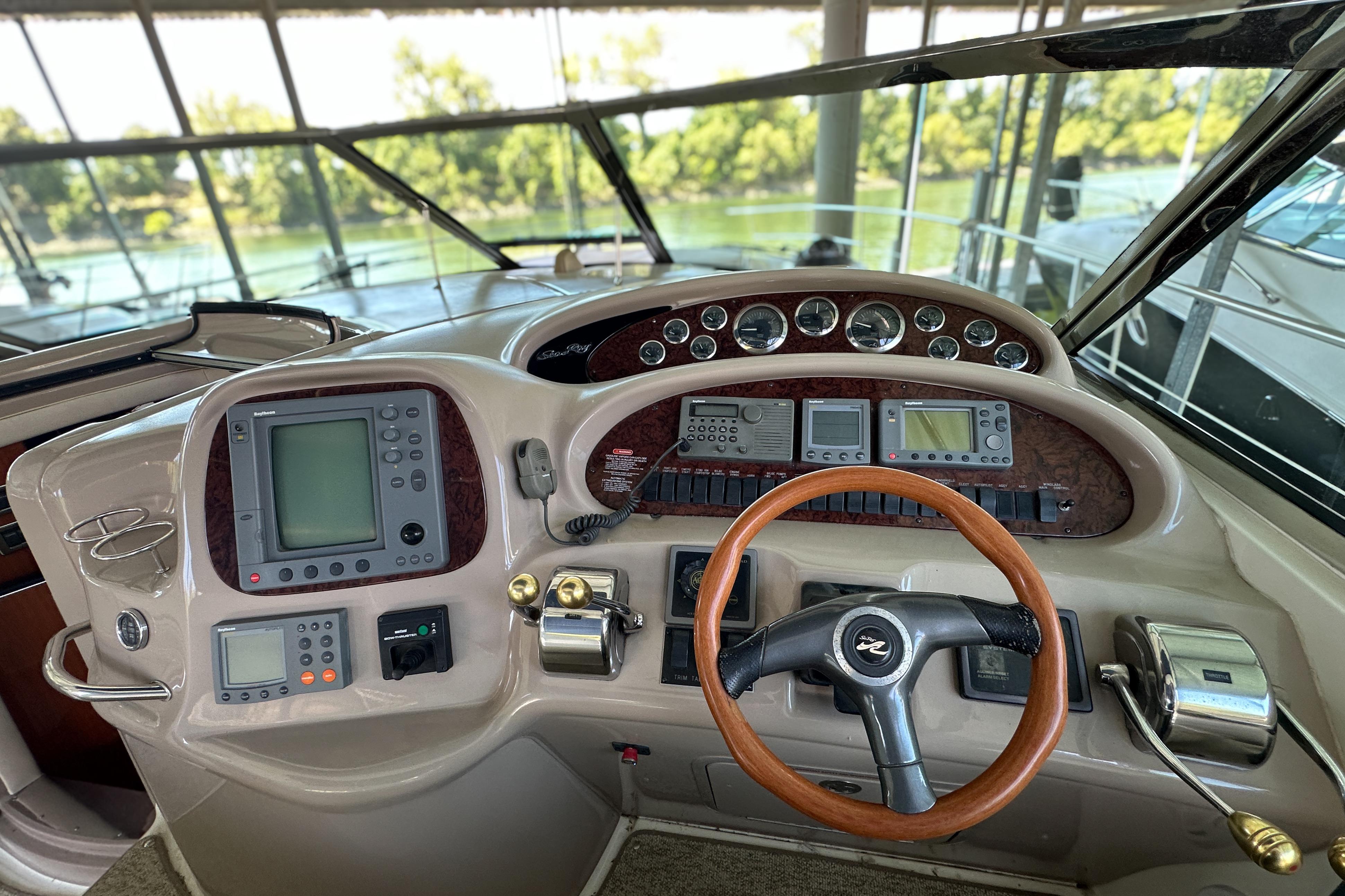 Cockpit of 2001 Sea Ray 410 Sundancer with navigation instruments and steering wheel.