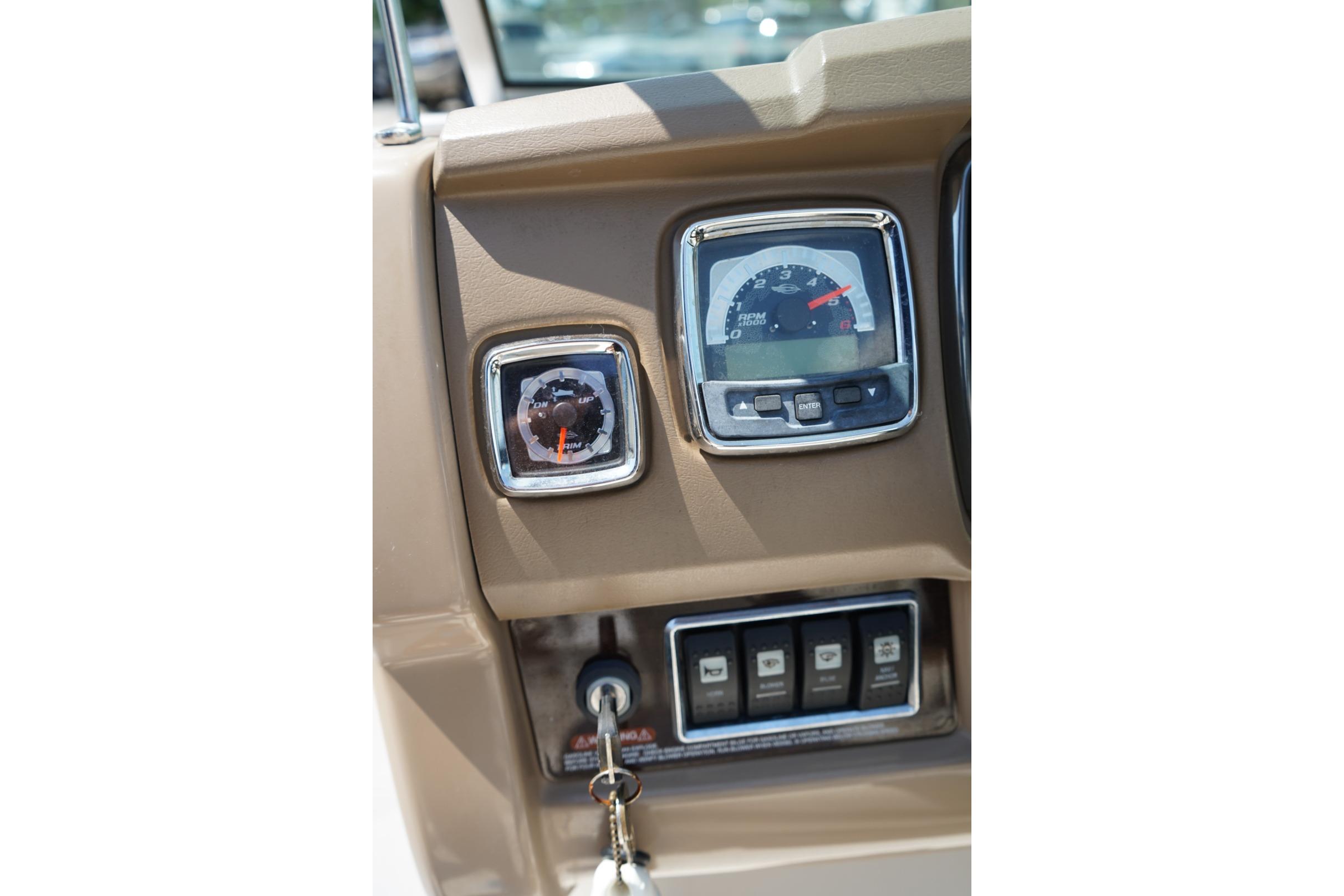 Dashboard of a 2013 Chaparral 206 SSi boat with gauges and controls.