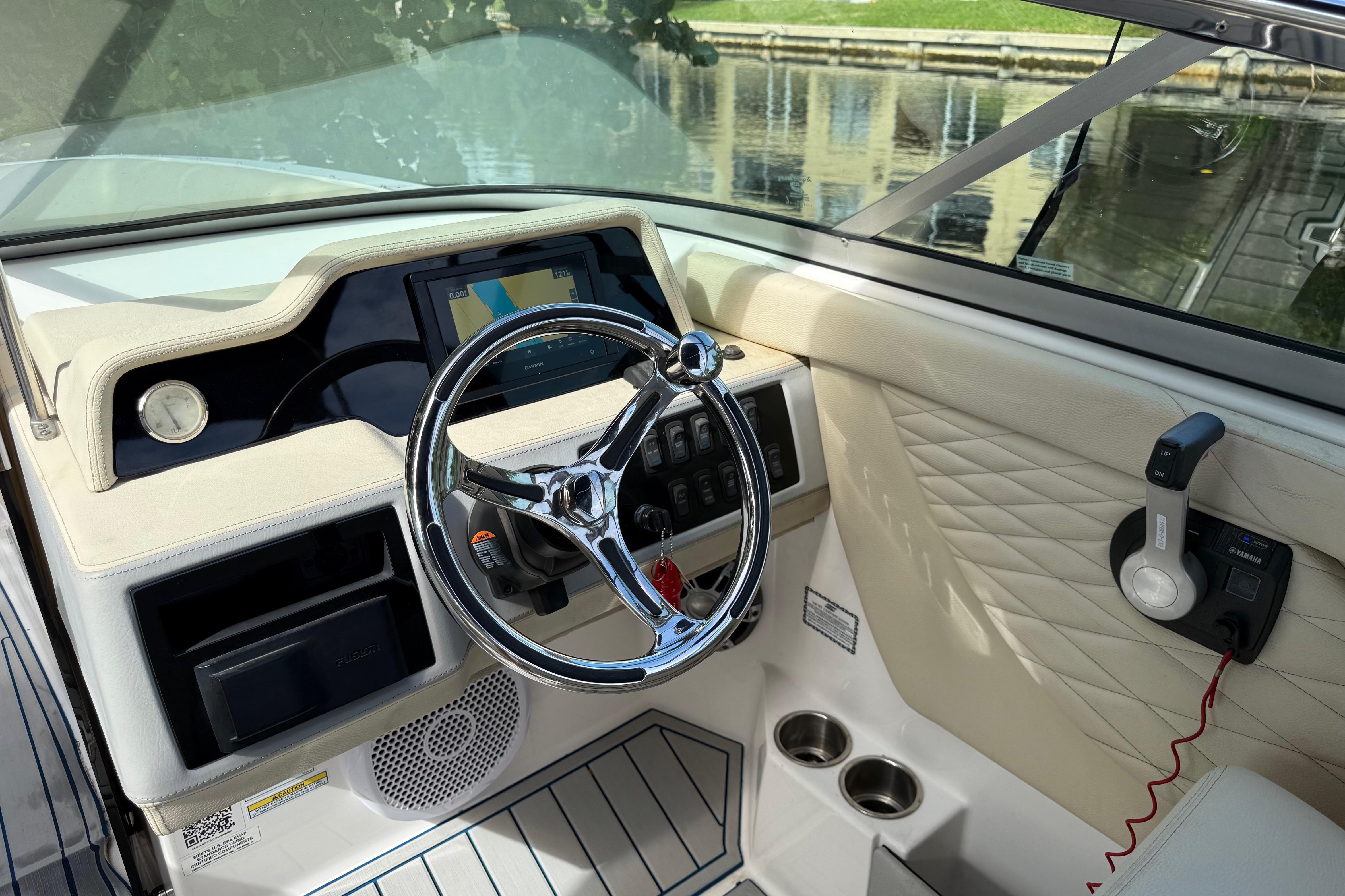 Interior view of 2021 Regal 26 OBX boat dashboard with steering wheel and controls.