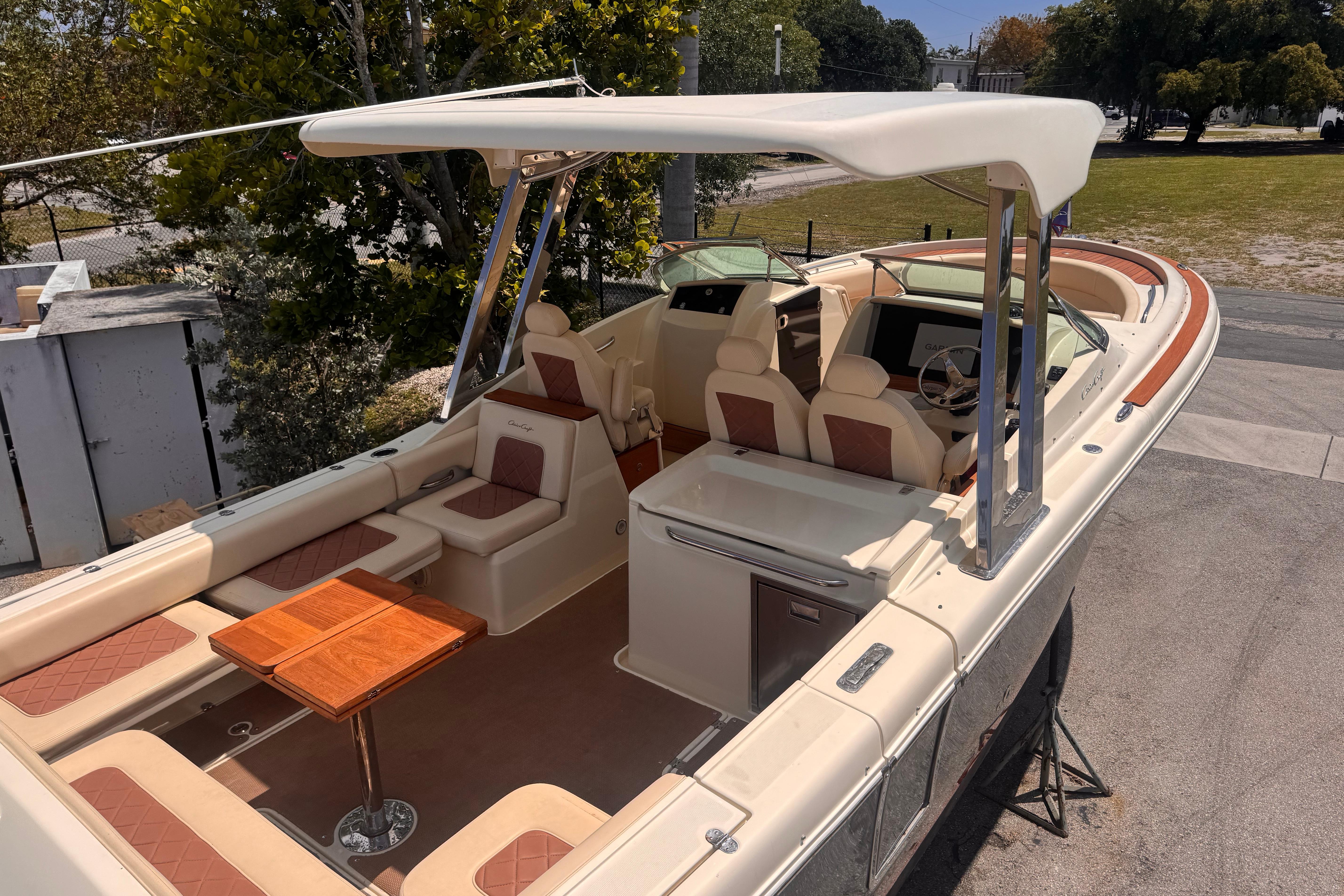 2018 Chris-Craft Calypso 30 boat with elegant seating and wooden accents.